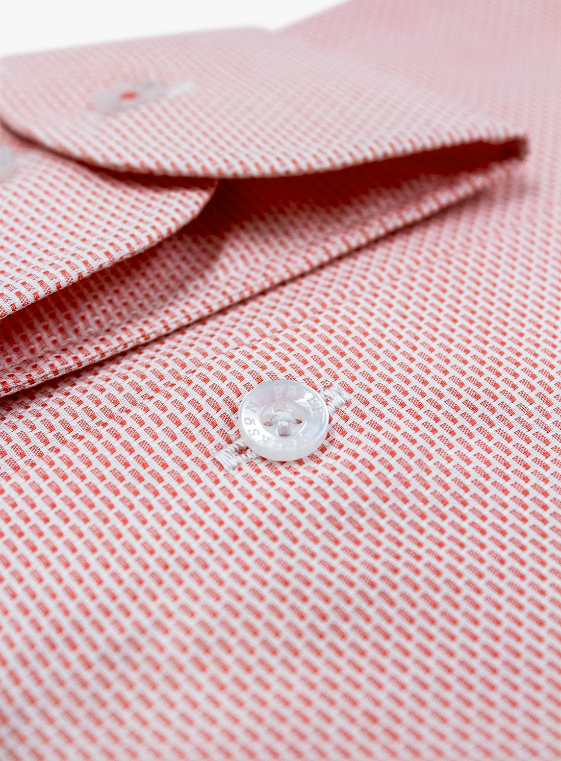 Close-up of a pink textured shirt with a button