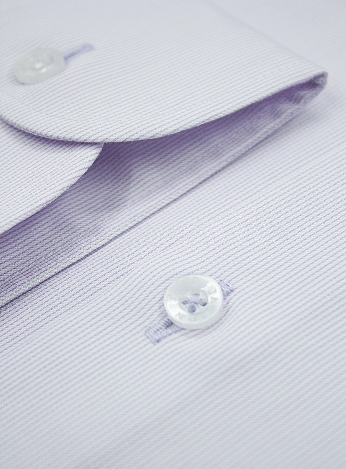 Close-up of a light purple dress shirt with buttons
