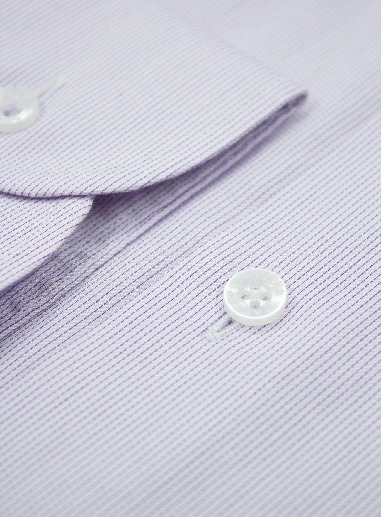 Close-up of a light purple shirt with a button and collar detail.