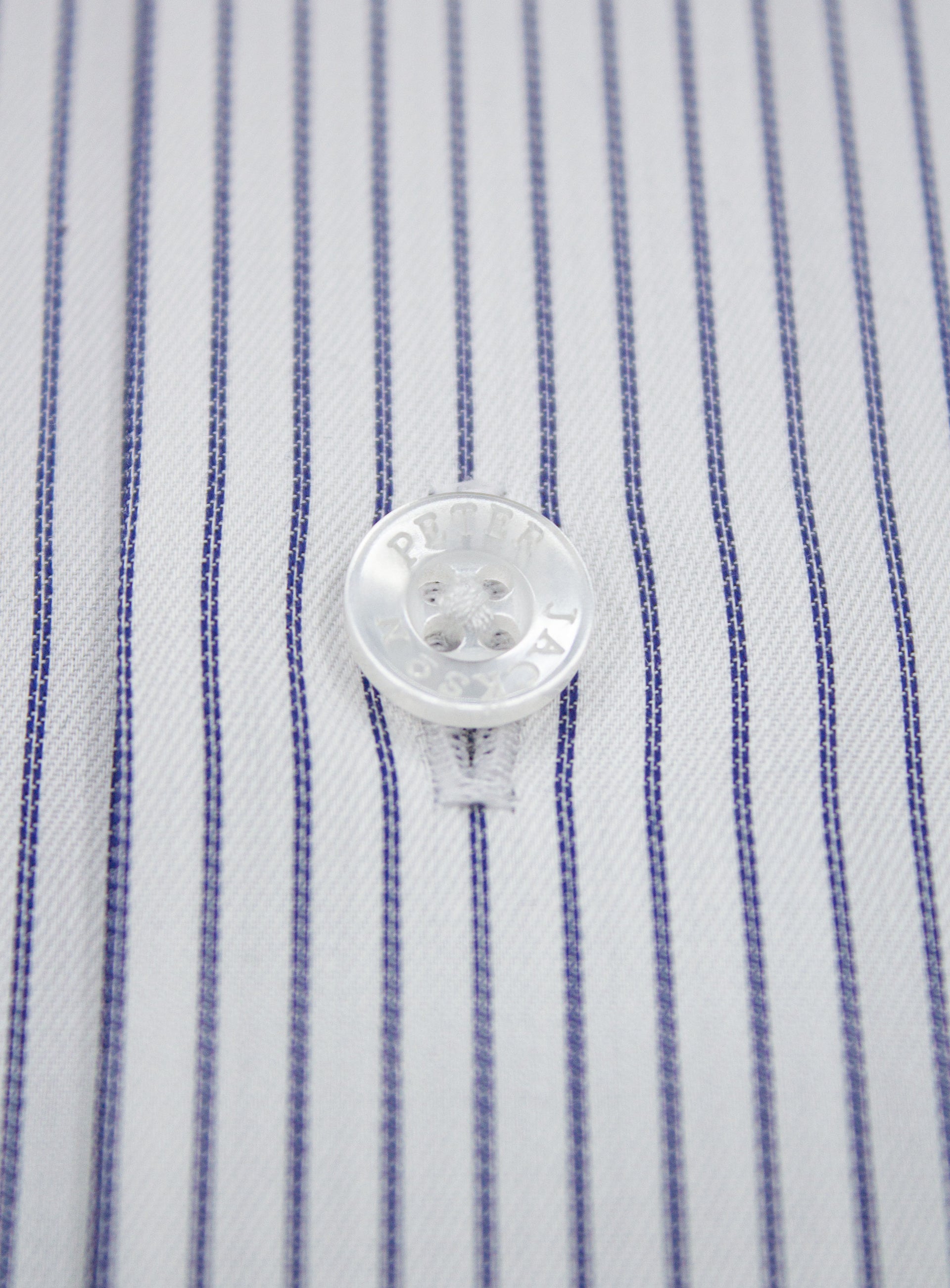 Close-up of a button on the Florence Navy Fine Stripe White Shirt