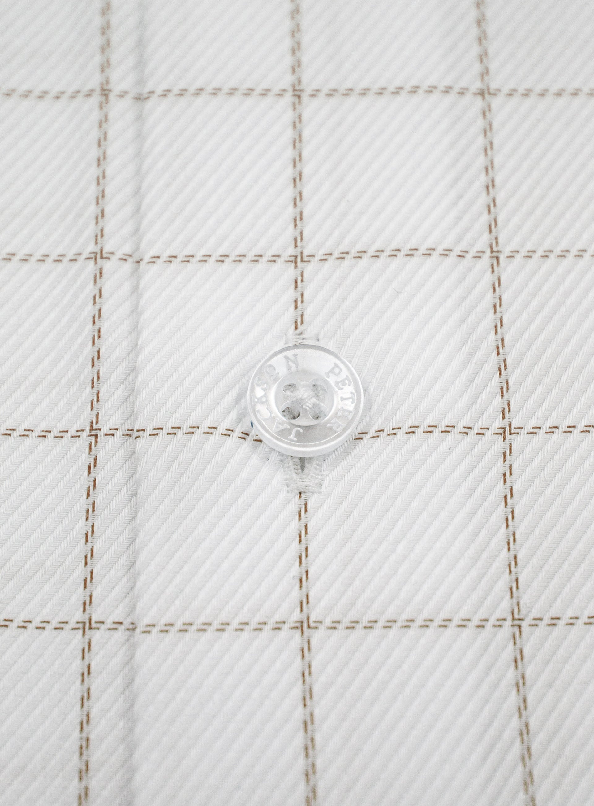 Close-up of a button on the Milan Twill Brown Mid-Check White Shirt