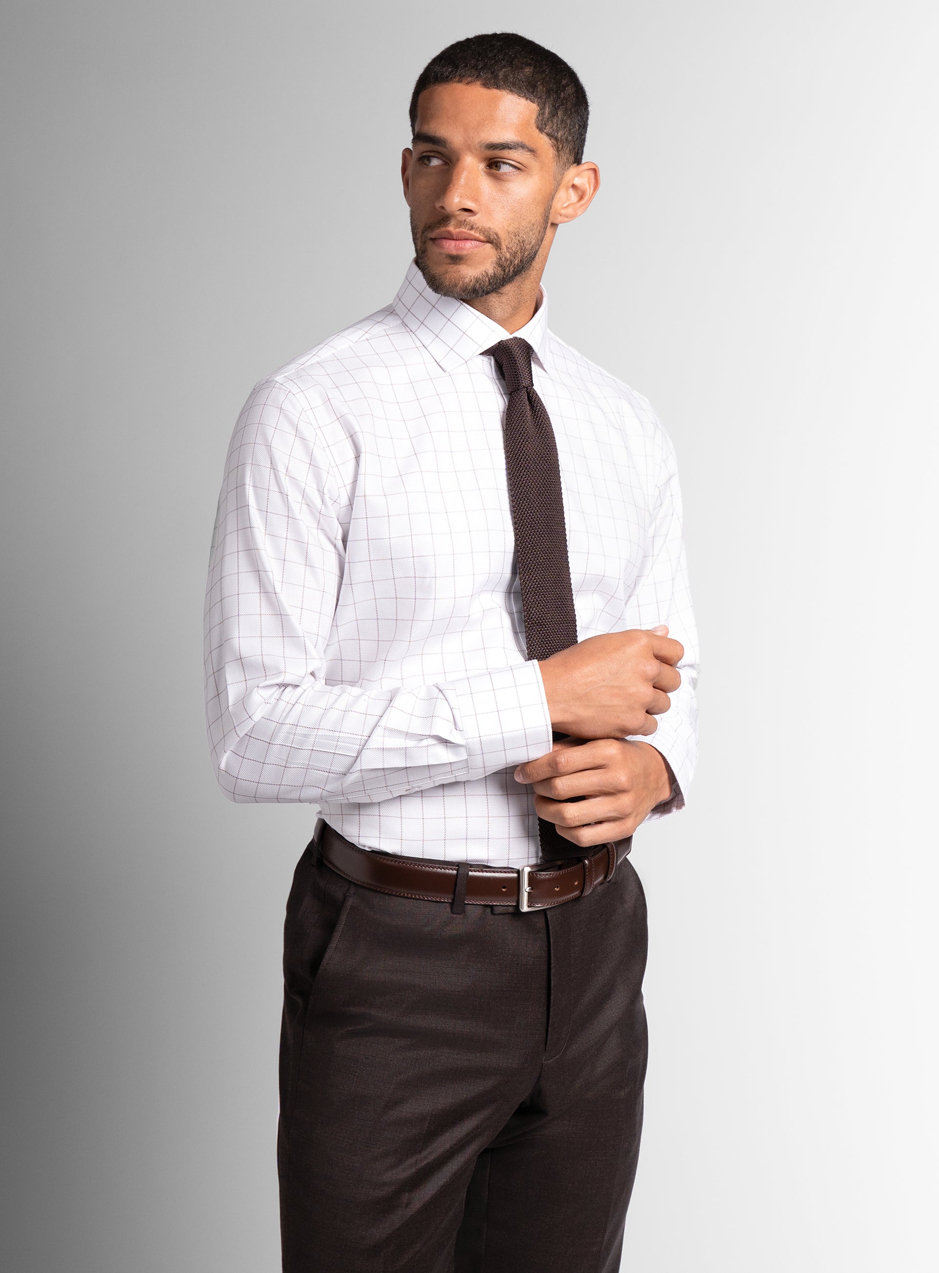 Man holding the cuffs on the Milan Twill Brown Mid-Check White Shirt