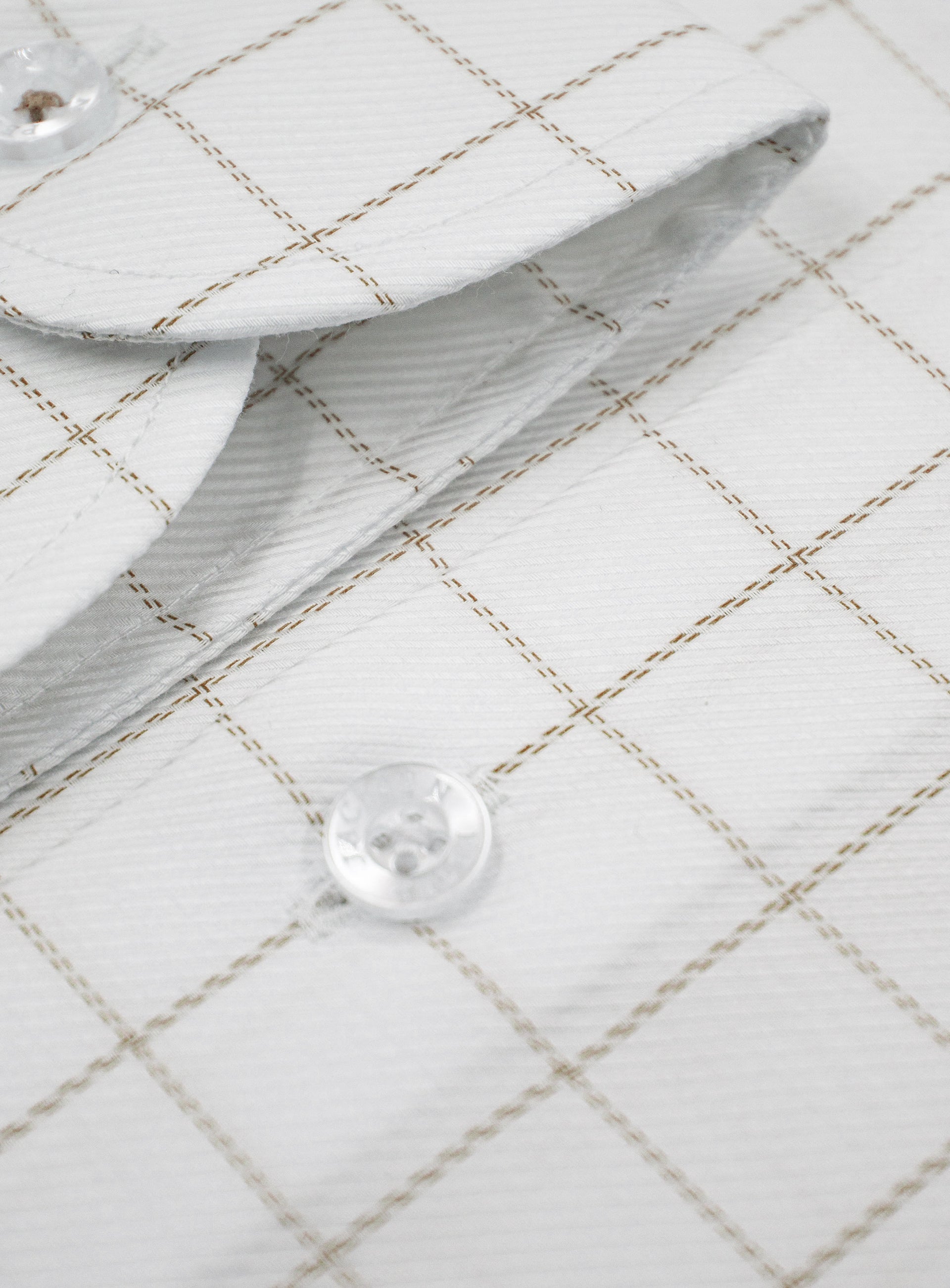 Close-up of a button on the Milan Twill Brown Mid-Check White Shirt