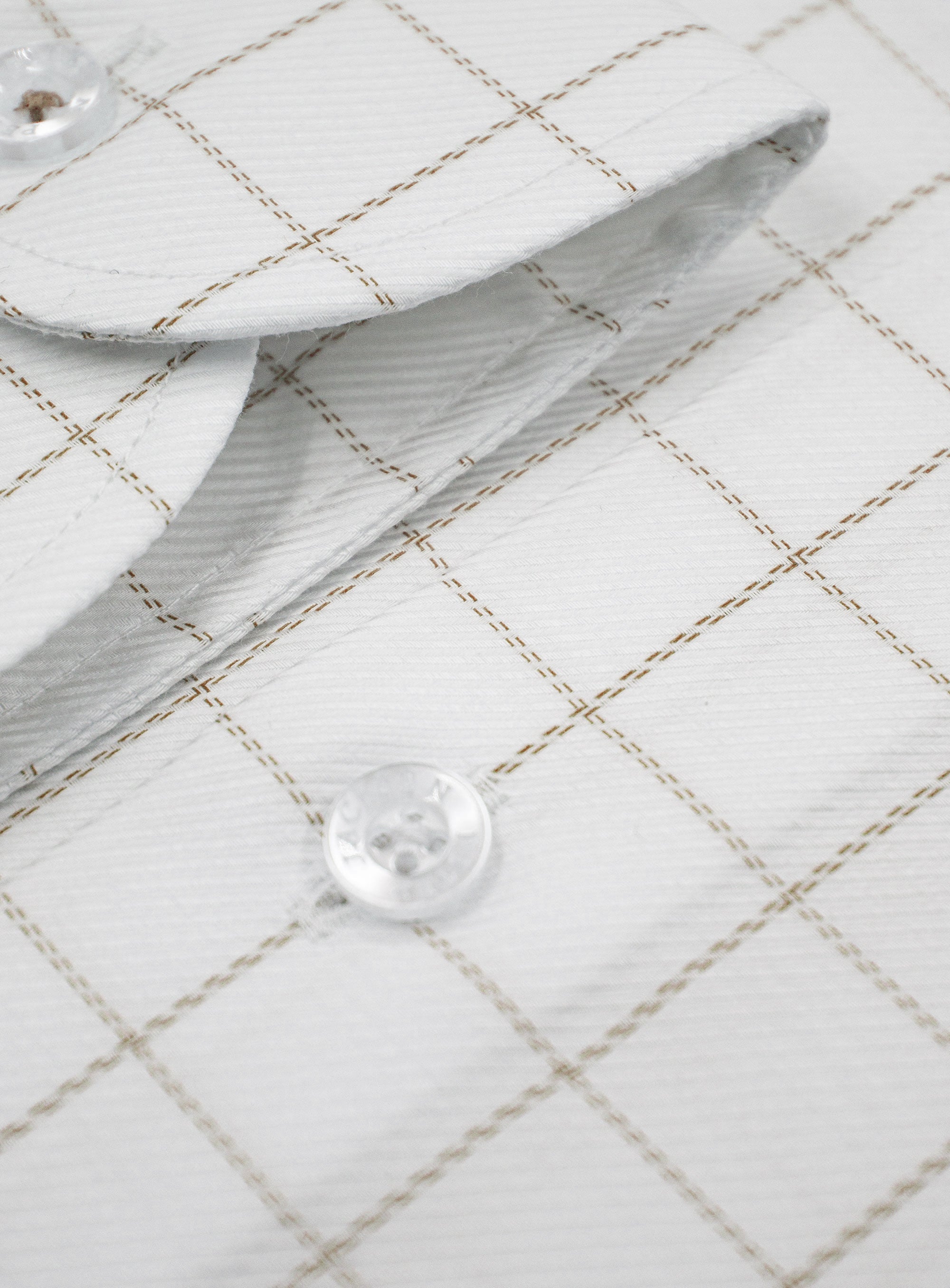 Close-up of a button on the Milan Twill Brown Mid-Check White Shirt
