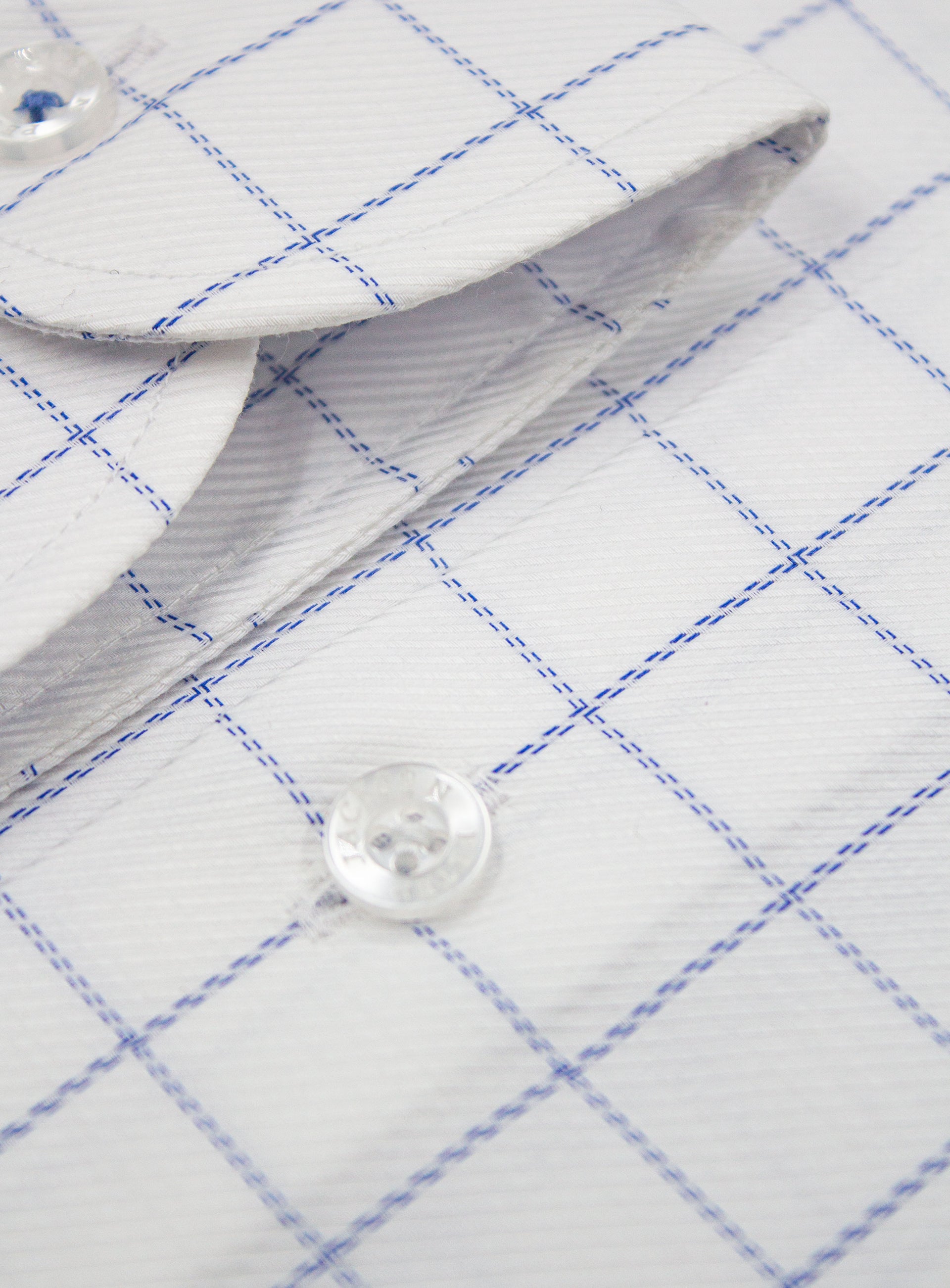 Close-up of a button on the Milan Twill Navy Mid-Check White Shirt