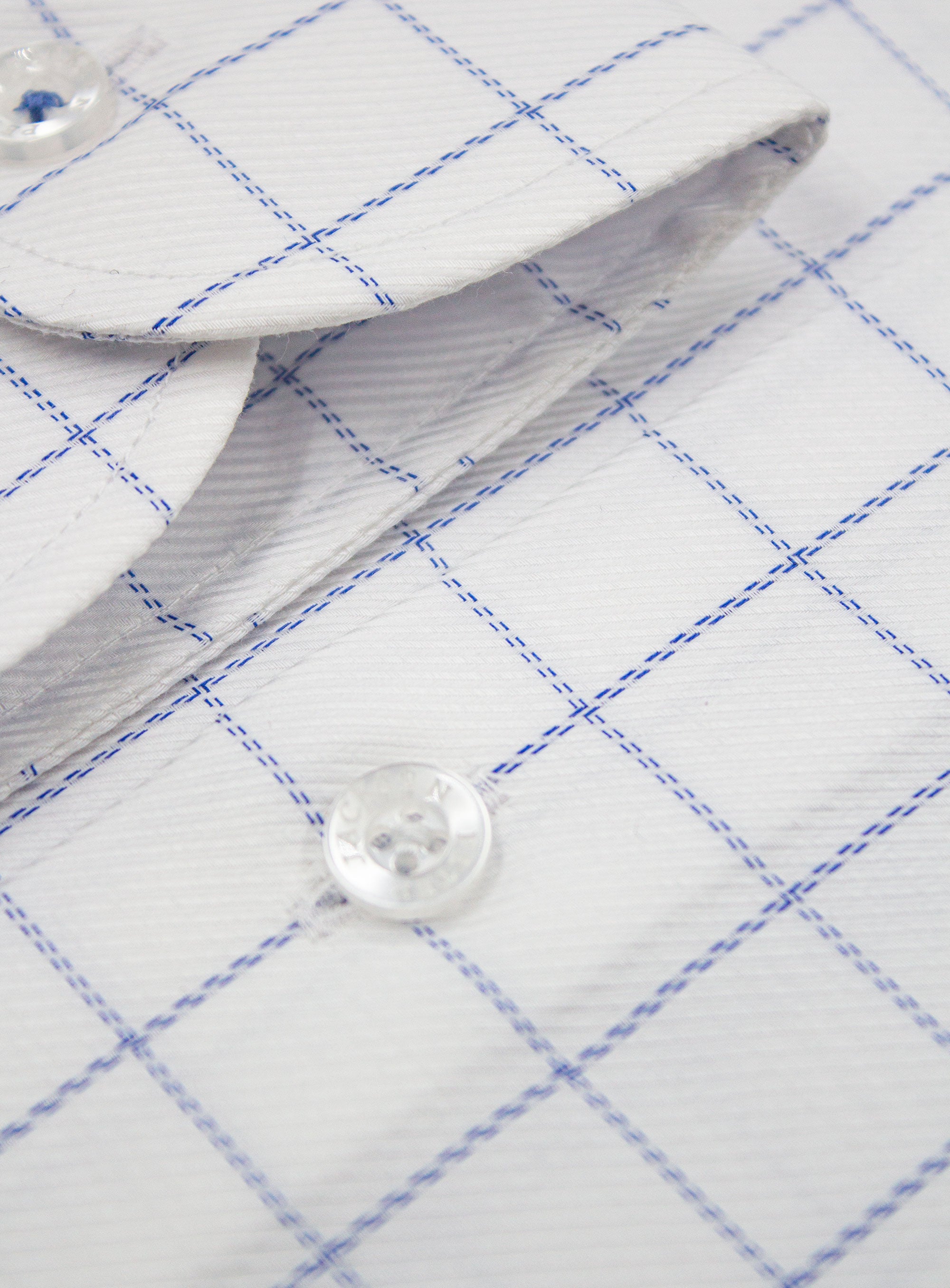 Close-up of a button on the Milan Twill Navy Mid-Check White Shirt