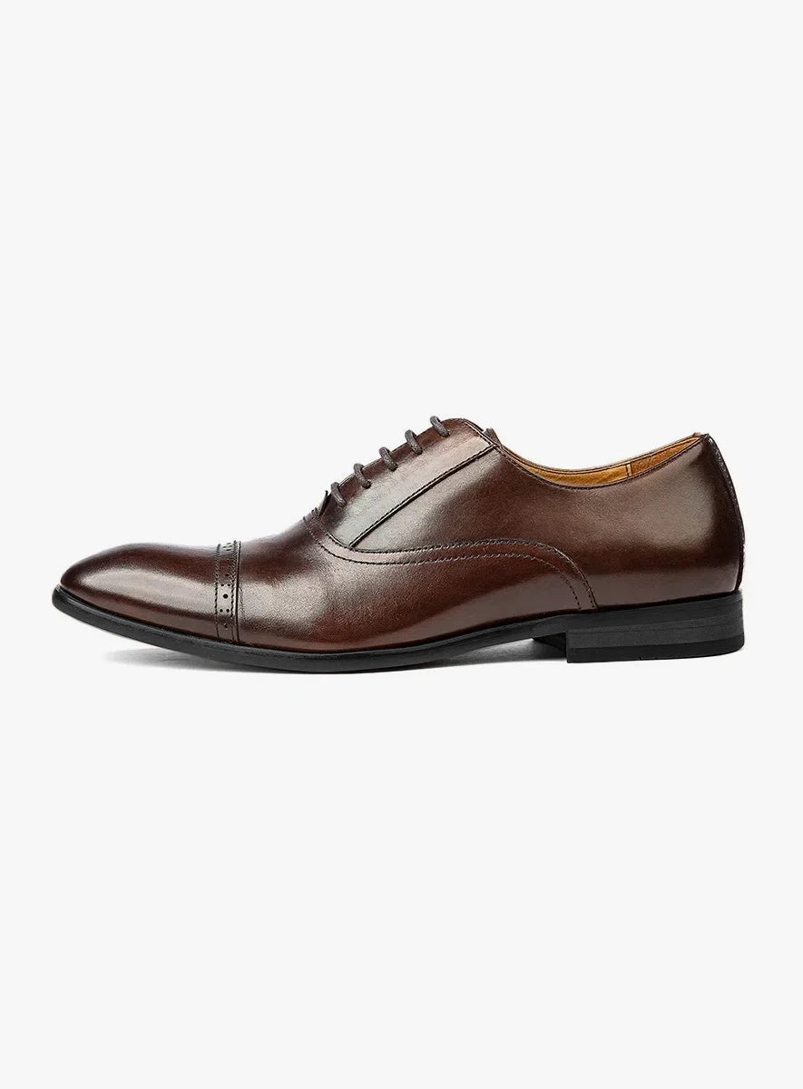 Brown leather dress shoe on a white background