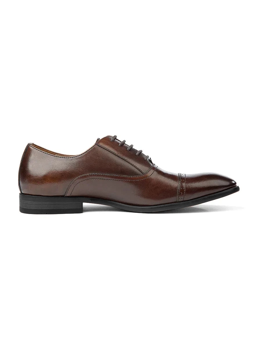 Brown leather dress shoe on a white background