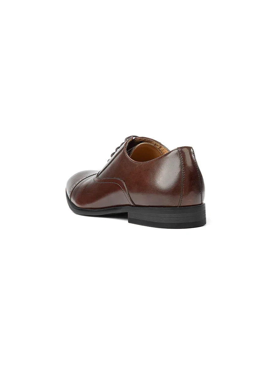 Brown leather dress shoe on a white background
