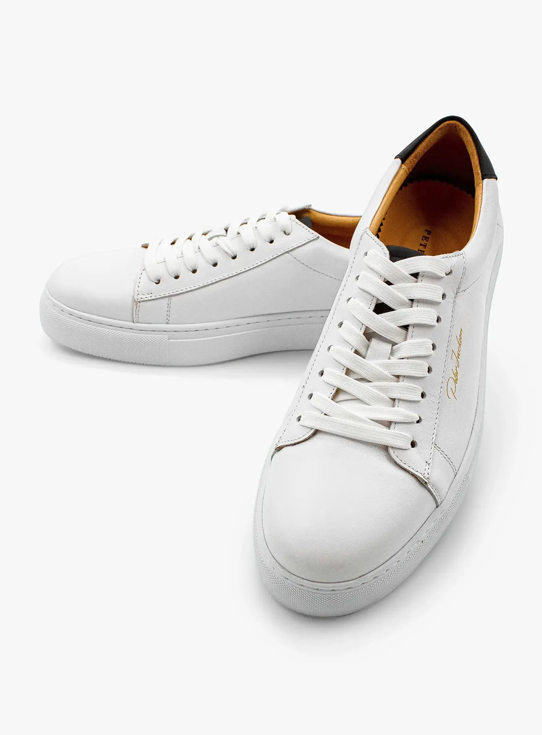 White sneakers with brown accents on a white background