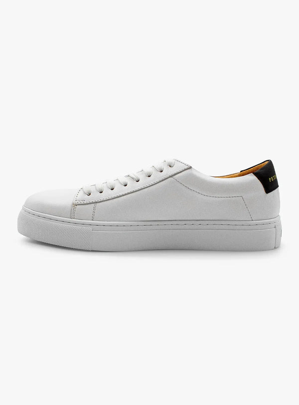 White sneaker with a black heel tab on a white background