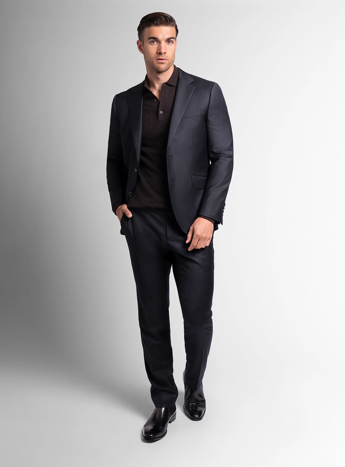 Man wearing a dark gray suit with a white background