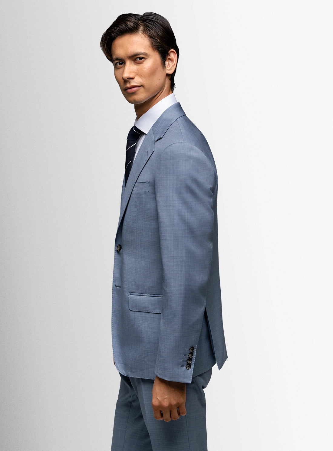Man wearing a light blue suit on a white background