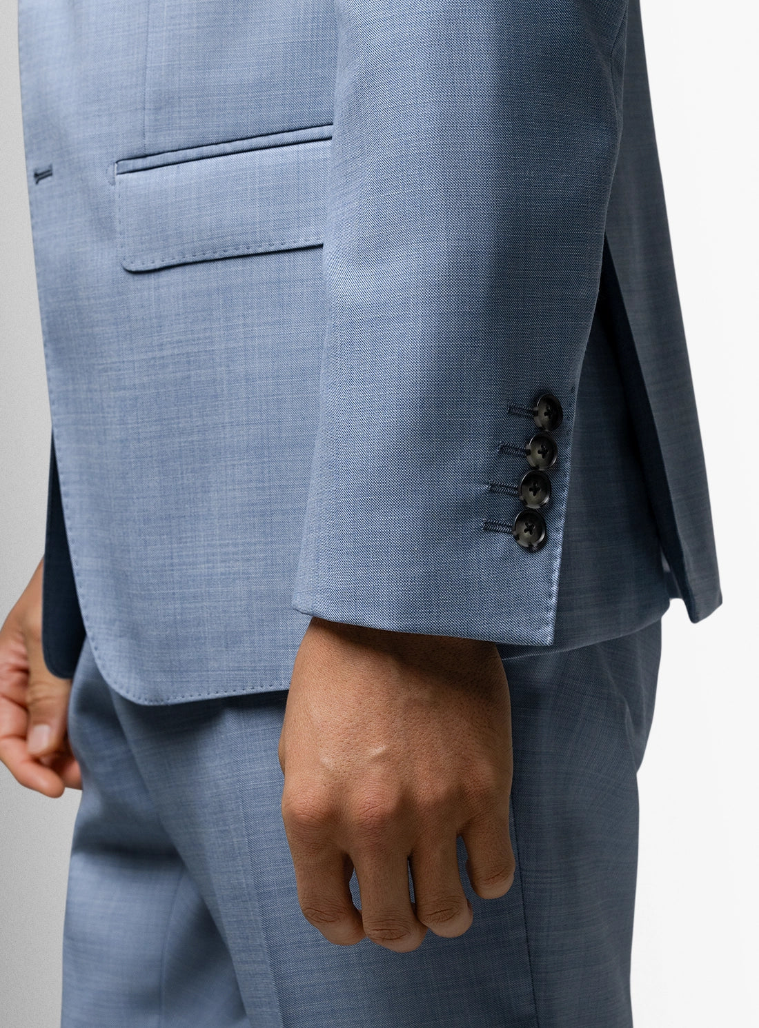 Close-up of a light blue suit with a gray background