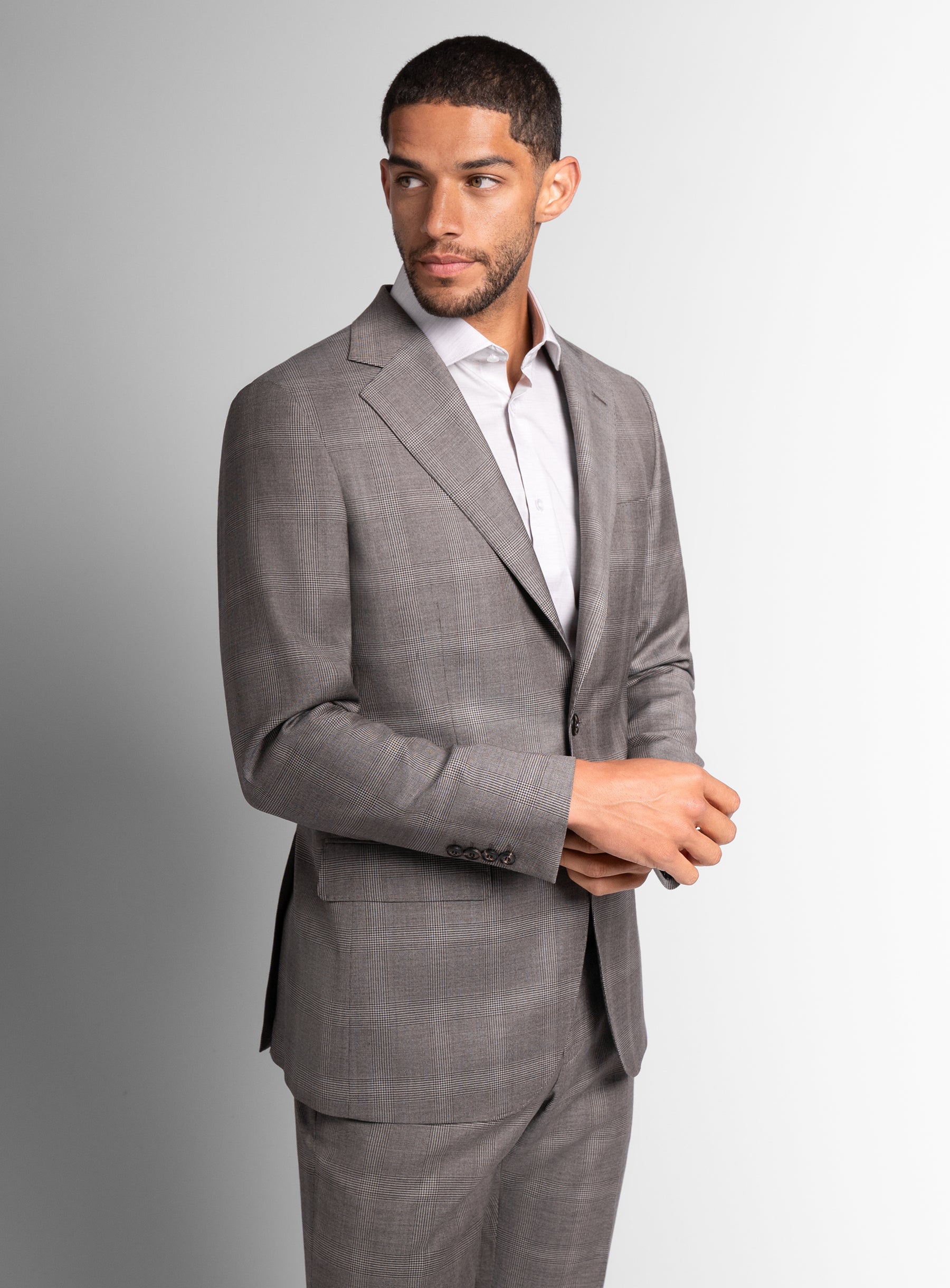 Man to his side wearing the Belnades Plaid Taupe Brown Suit