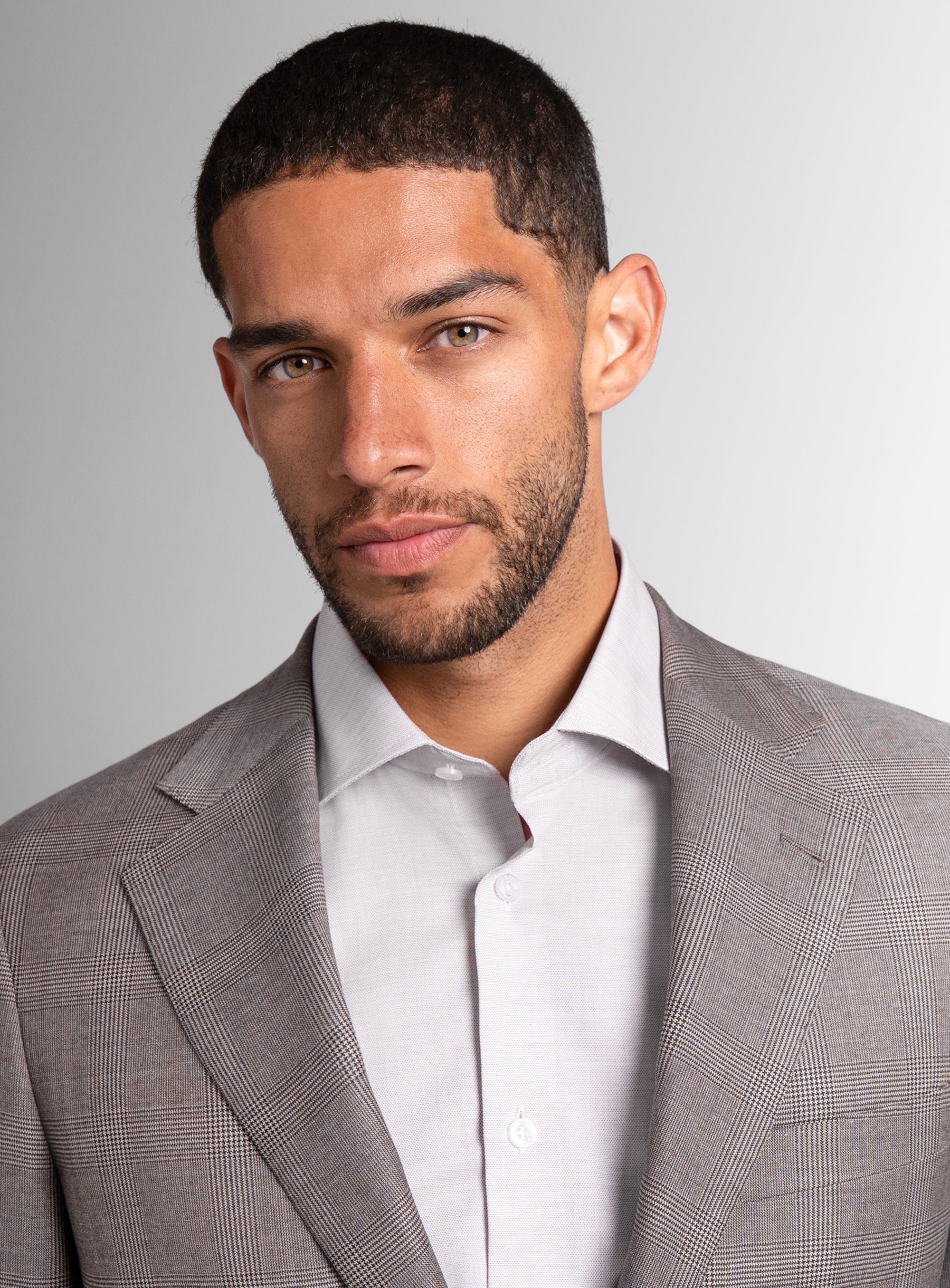 Close-up of man wearing the Belnades Plaid Taupe Brown Suit
