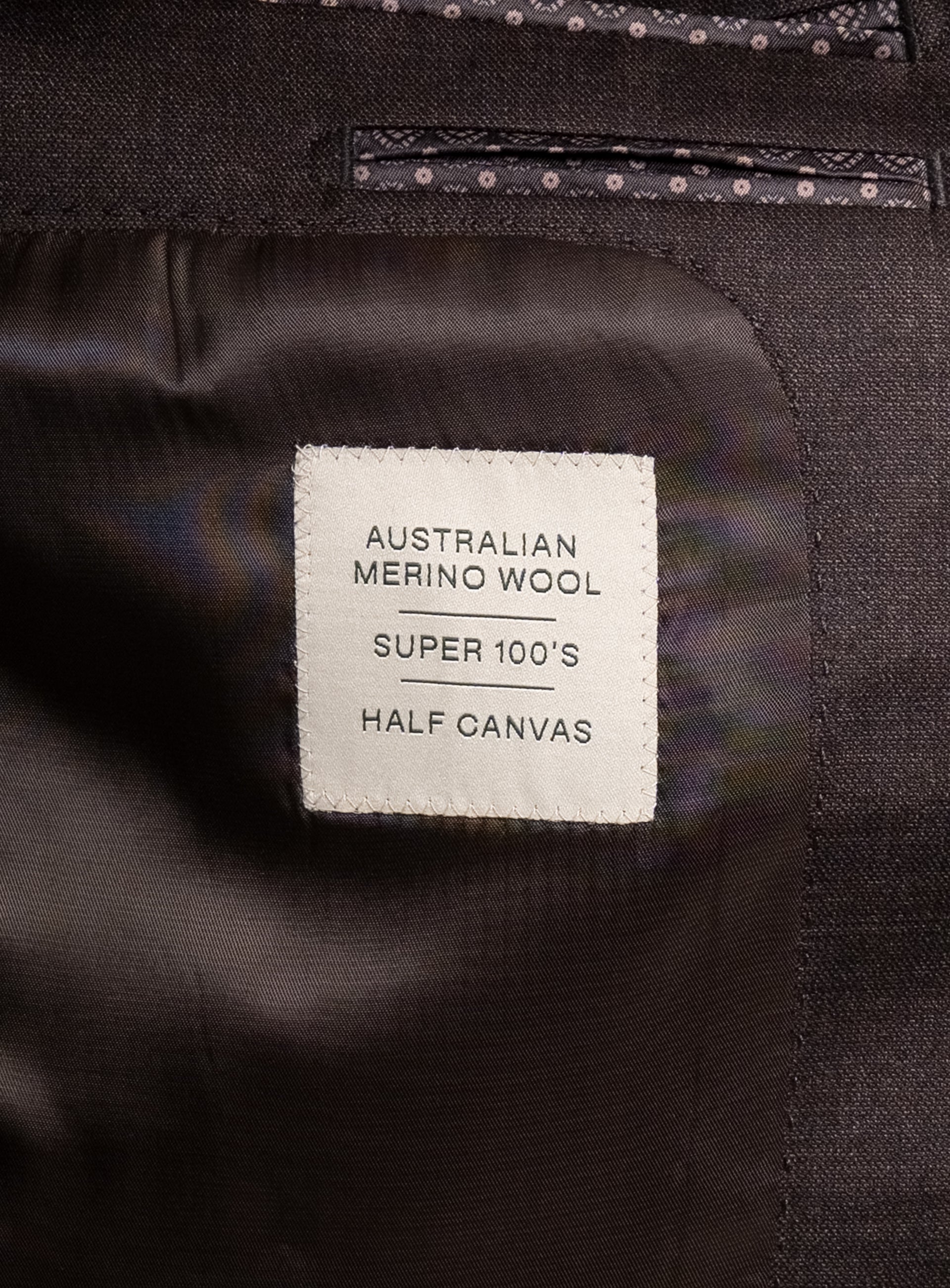 Label that says "Australian Merino Wool - Super 100's - Half Canvas" on the Vespucci Sharkskin Chocolate Brown Suit