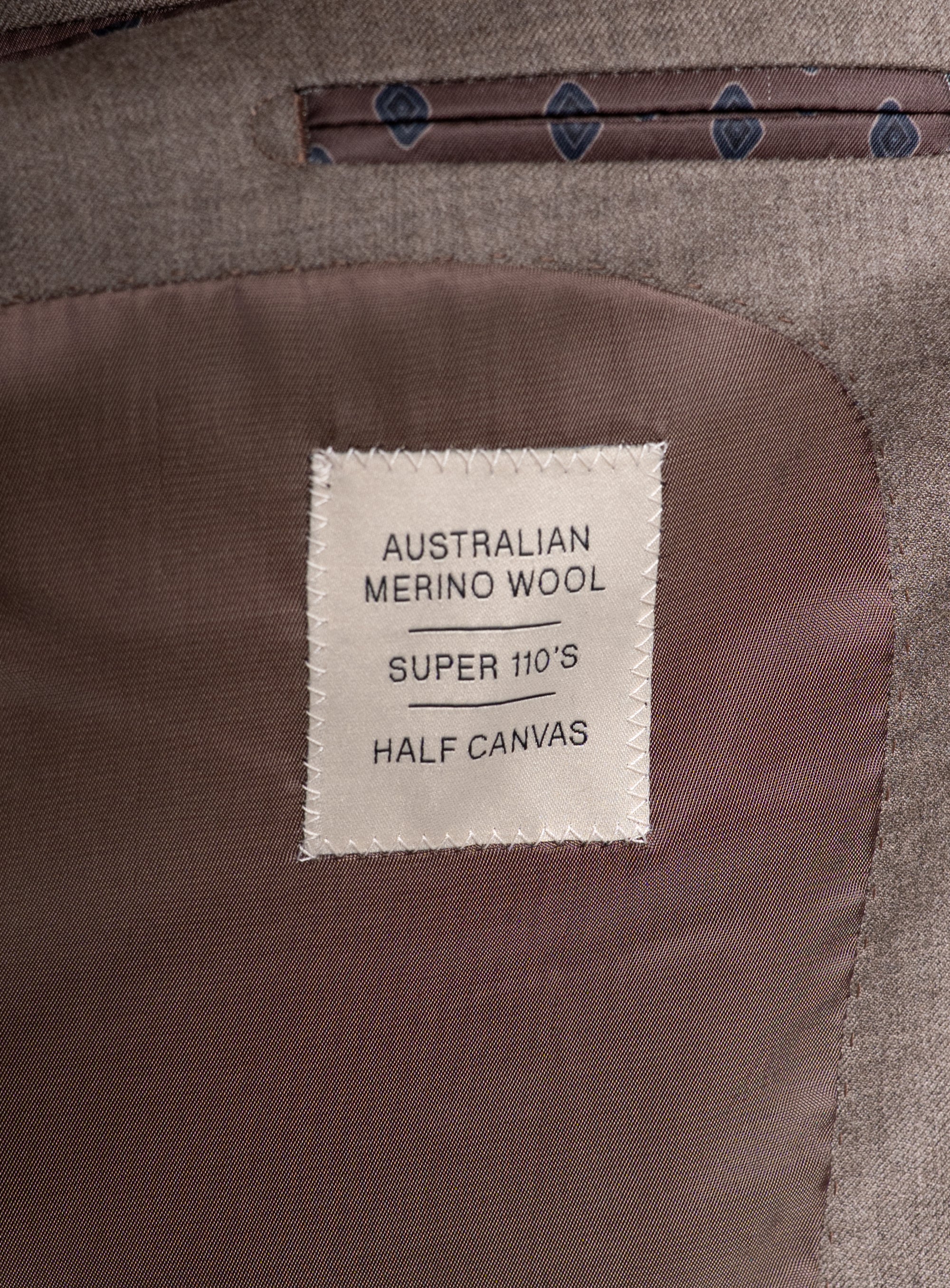 Label on the Tattaglia Twill Taupe Suit that says "Australian Merino Wool - Super 110's - Half Canvas"