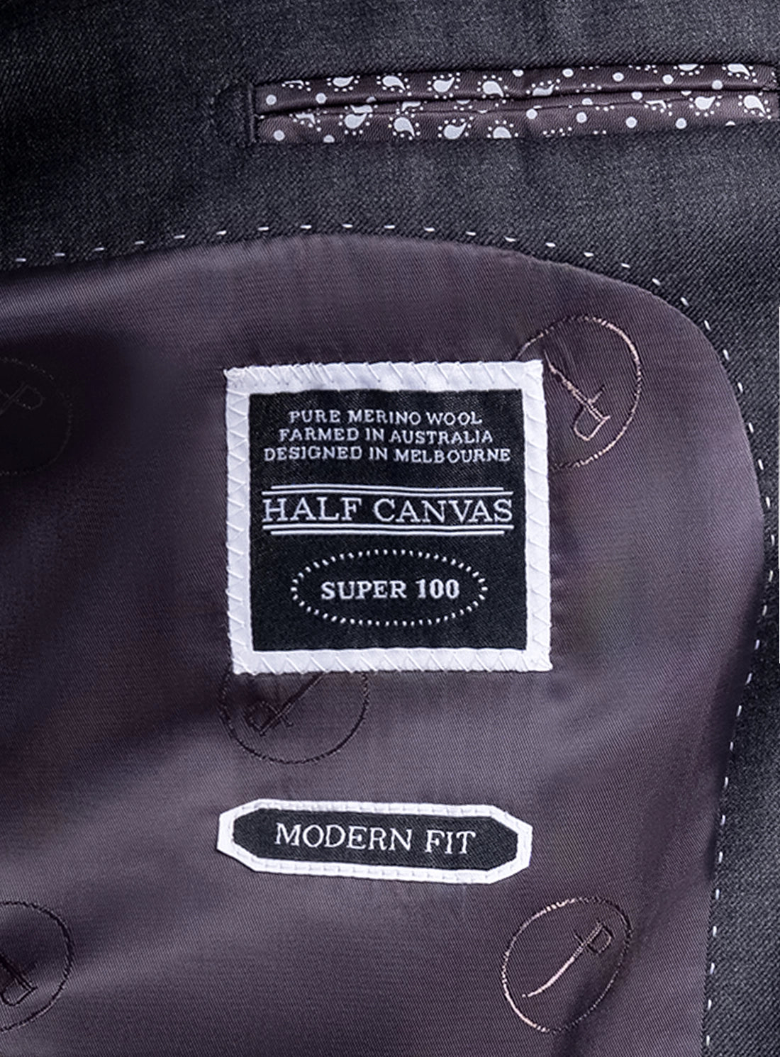 Label on a suit jacket indicating 'Half Canvas' brand and details about fabric and fit.