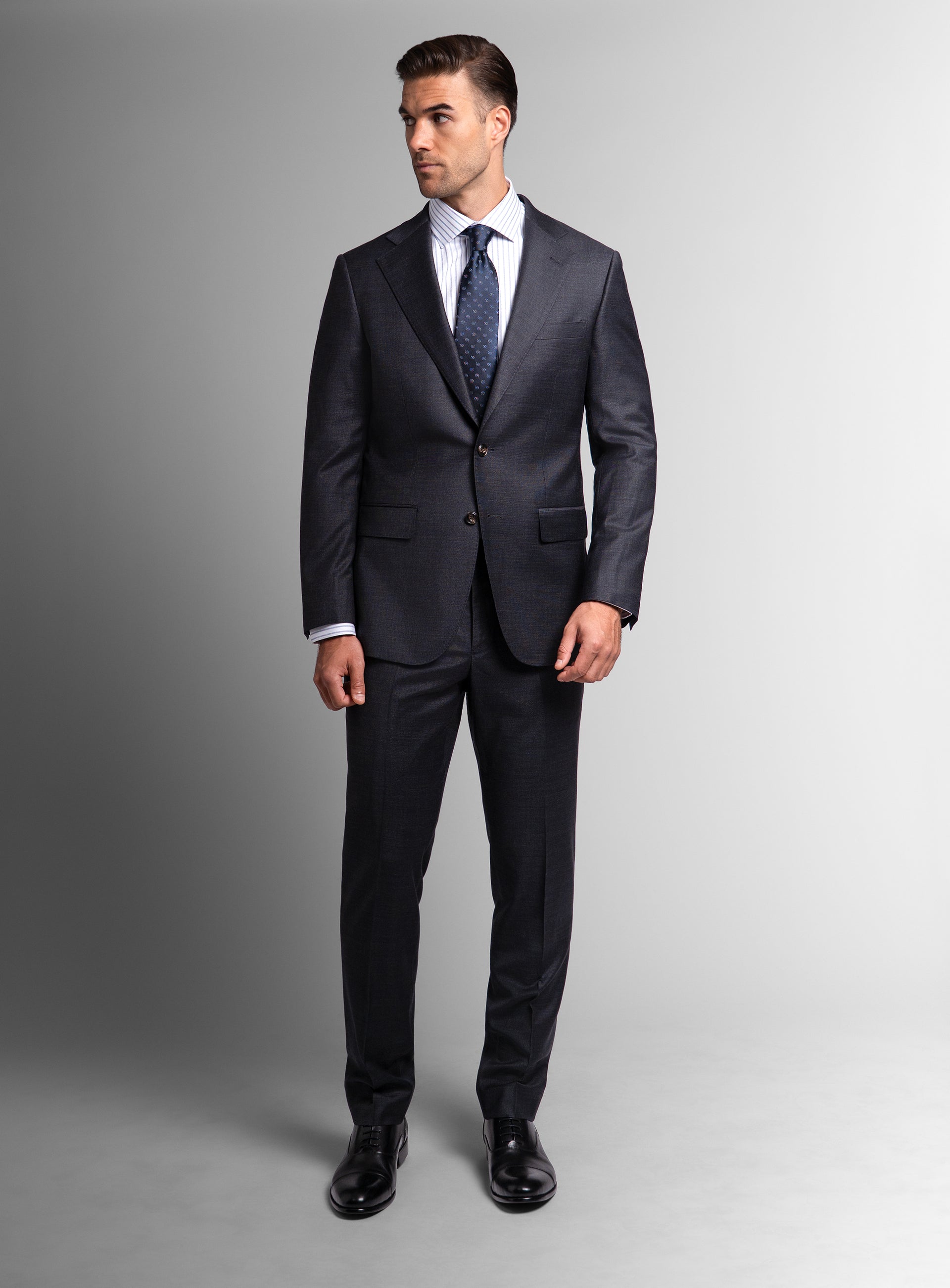 Man looking to his other side, wearing the Belmondo Charcoal Grey Suit