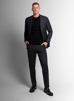 Man wearing charcoal grey suit on a grey background