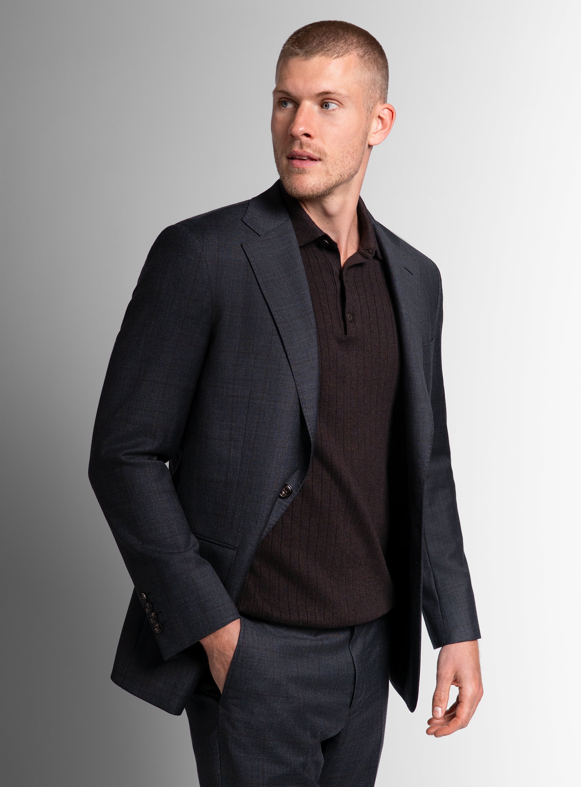 Man looking to his side, wearing the Auditore Check Charcoal Grey Suit