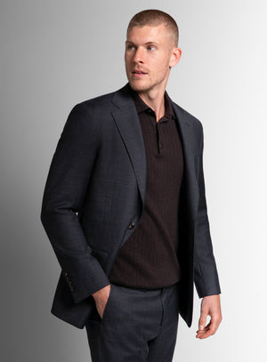 Man looking to his side, wearing the Auditore Check Charcoal Grey Suit