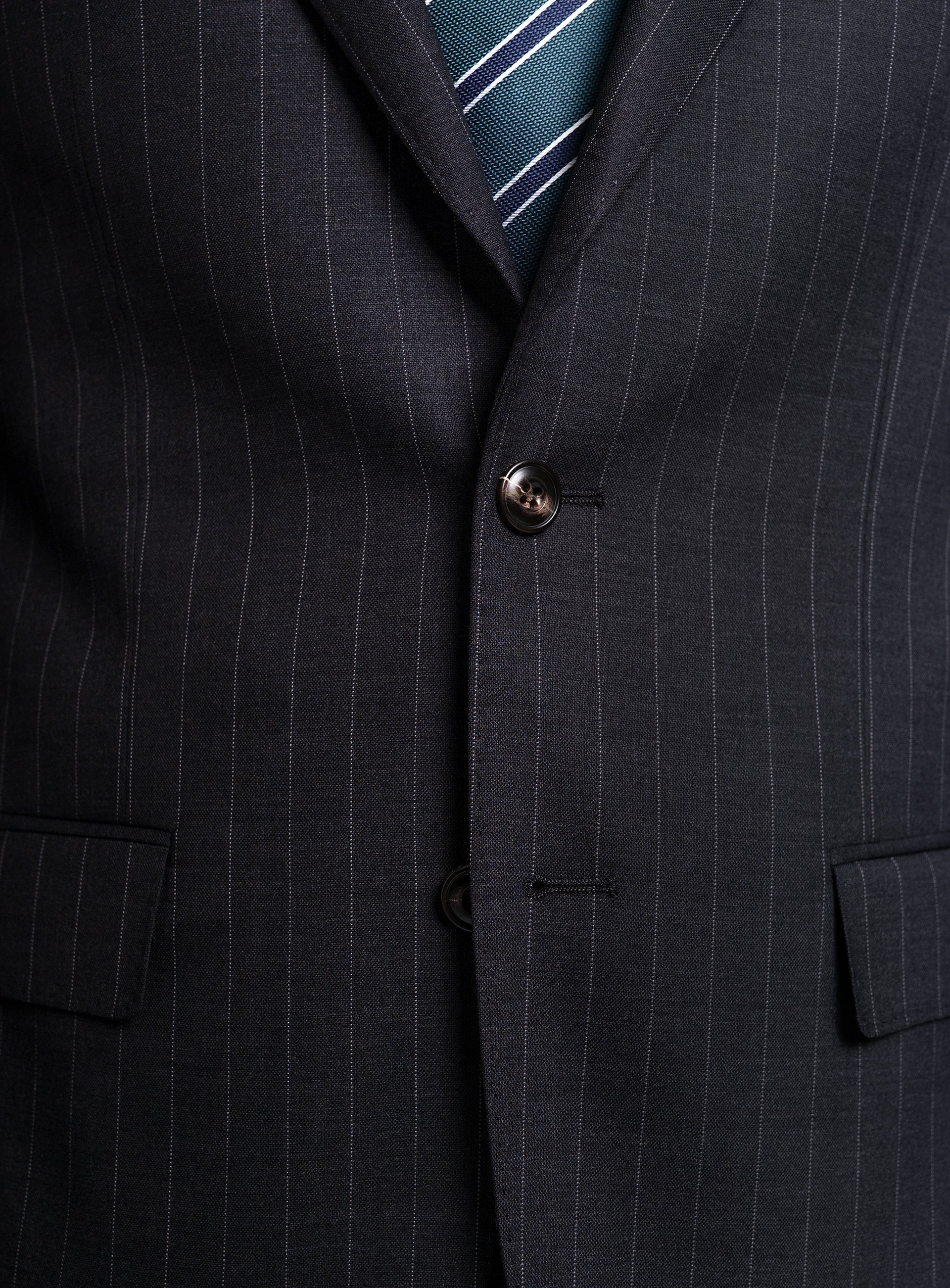 The Petruccio Charcoal Pinstripe Suit buttoned-up