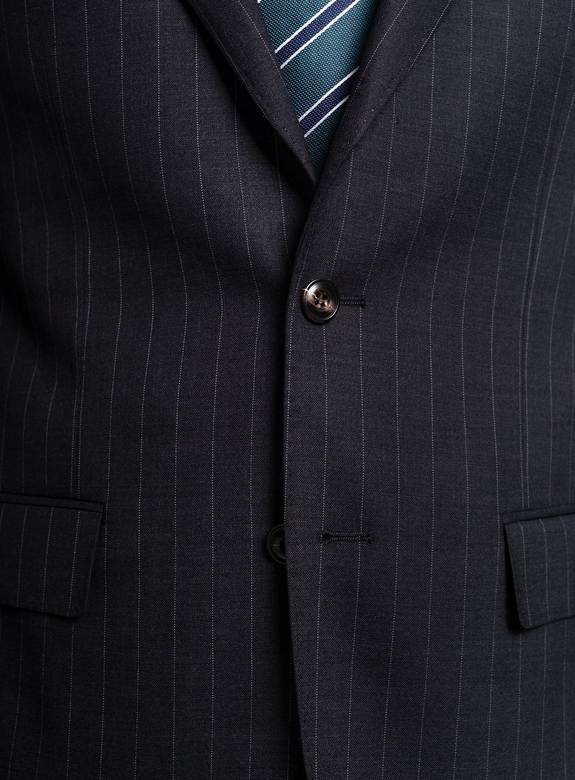 The Petruccio Charcoal Pinstripe Suit buttoned-up