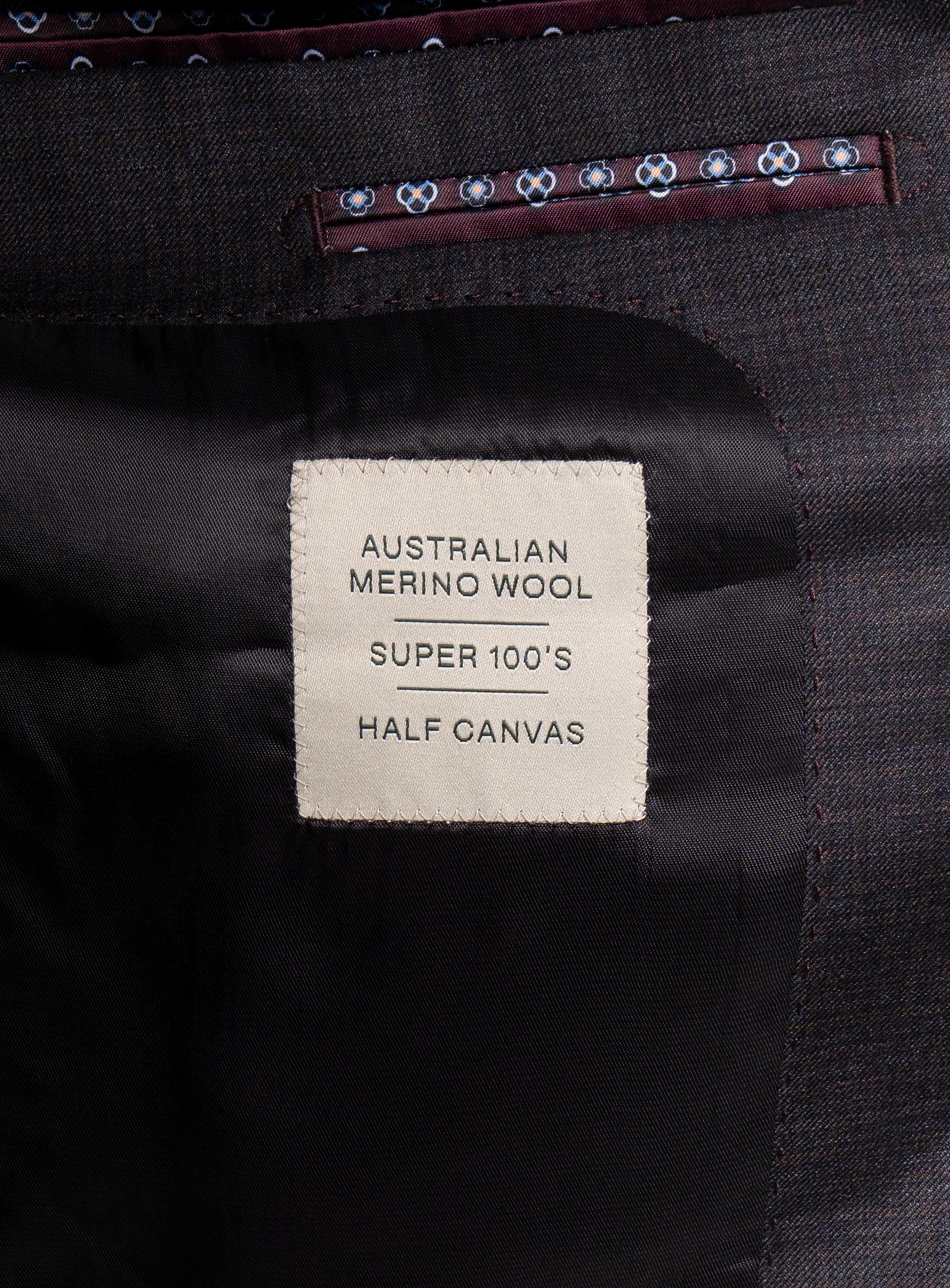Label that says "Australian Merino Wool - Super 100's - Half Canvas" on the Auditore Charcoal and Brown Suit