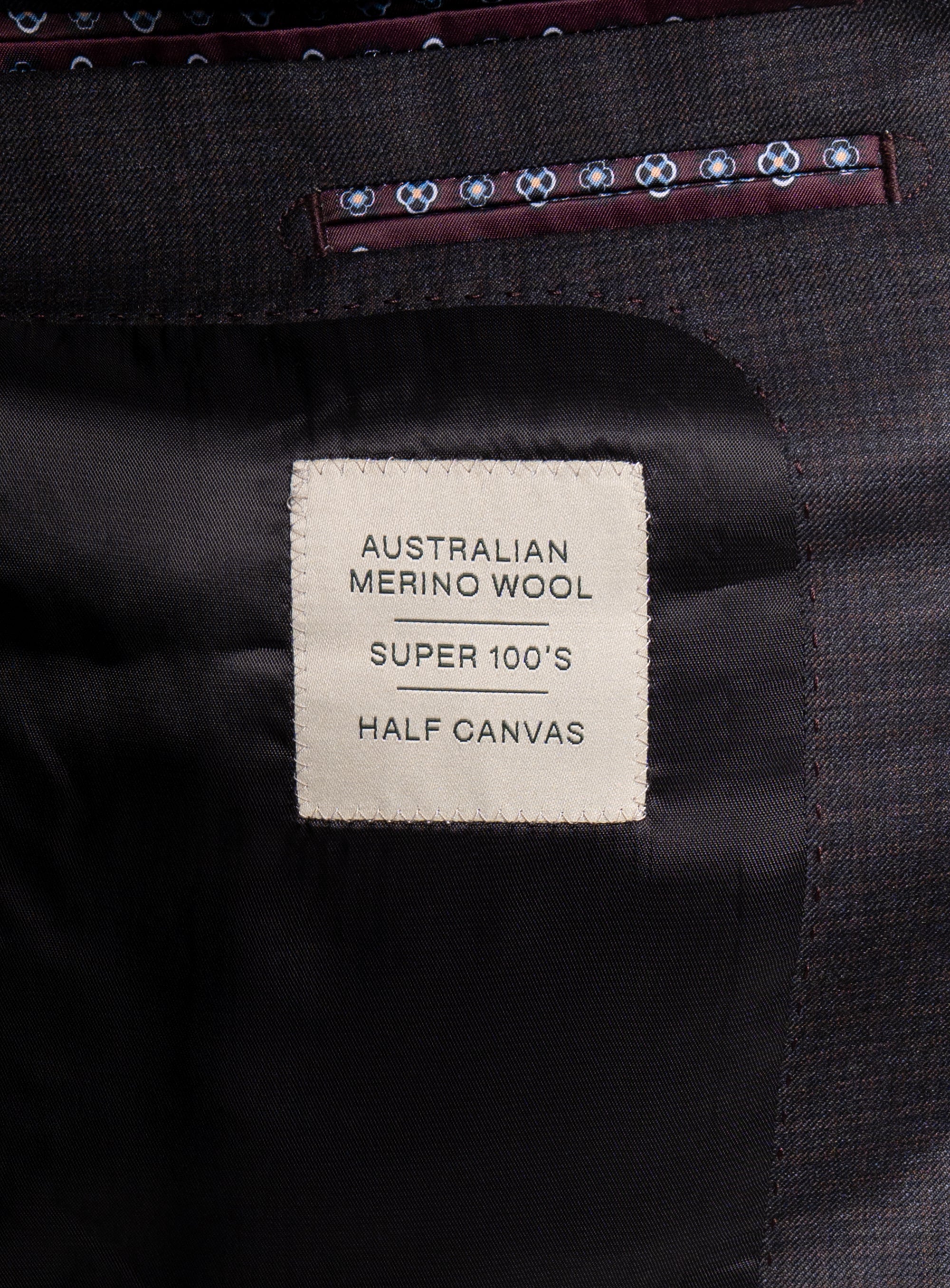 Label that says "Australian Merino Wool - Super 100's - Half Canvas" on the Auditore Charcoal and Brown Suit