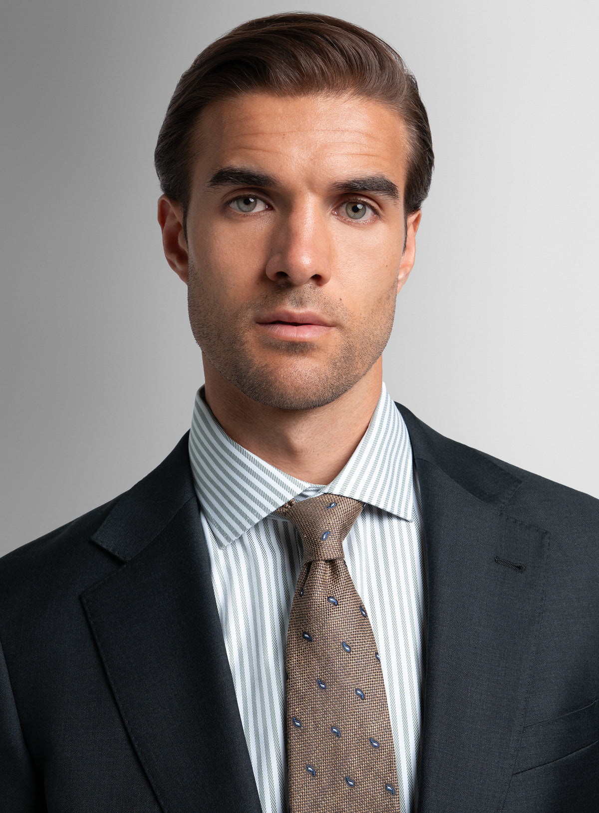 Close-up of a man wearing the Brunello Twill Charcoal Grey Suit