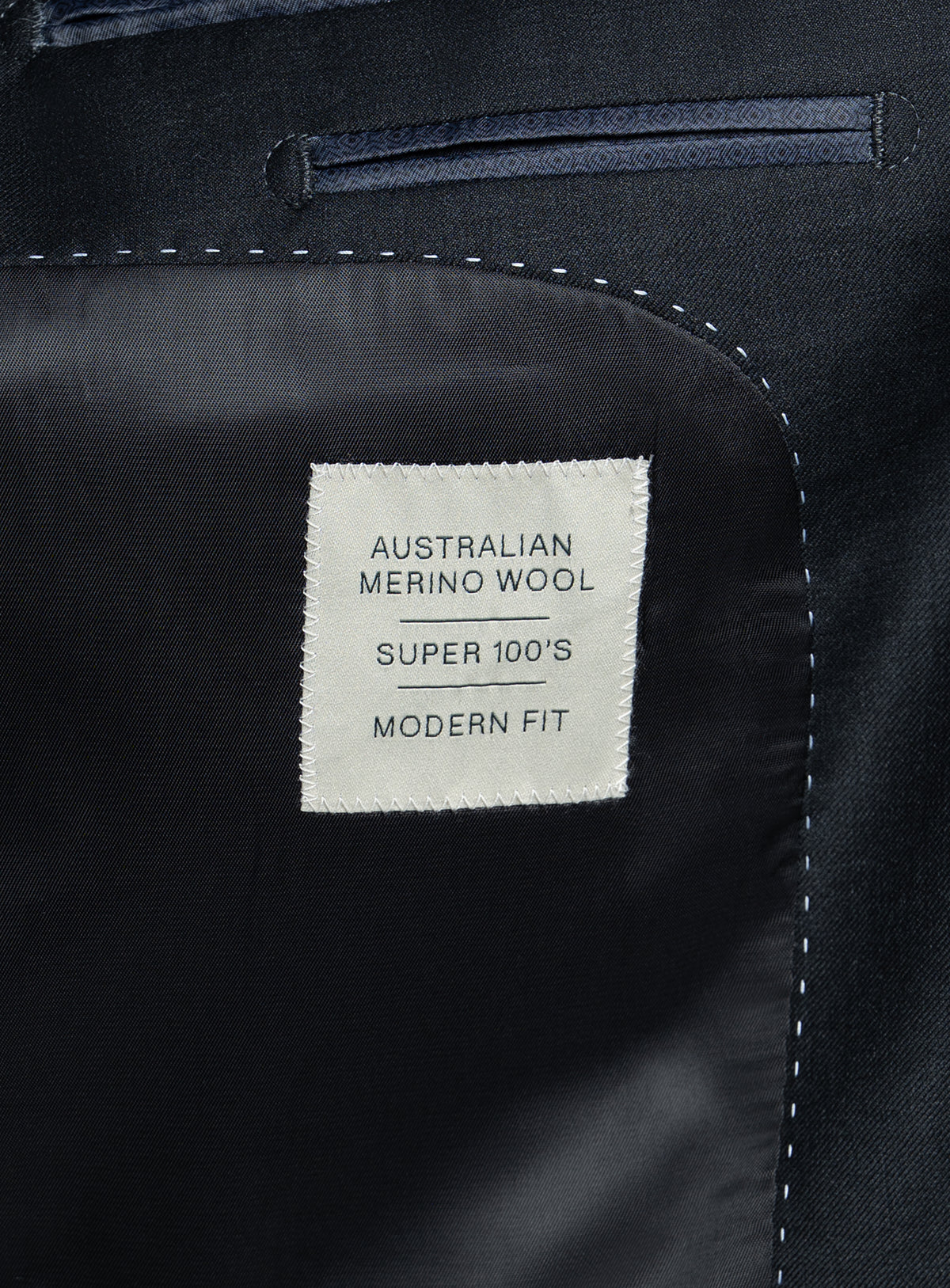 A label on the Brunello Twill Charcoal Grey Suit that says "Australian Merino Wool - Super 100's - Modern Fit"