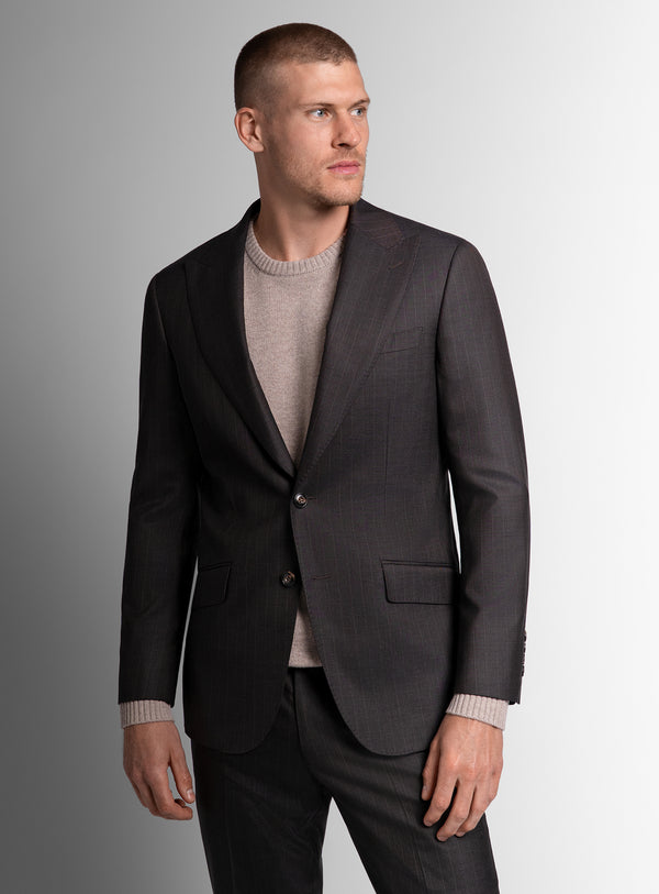 Man wearing a brown suit on a gradient background