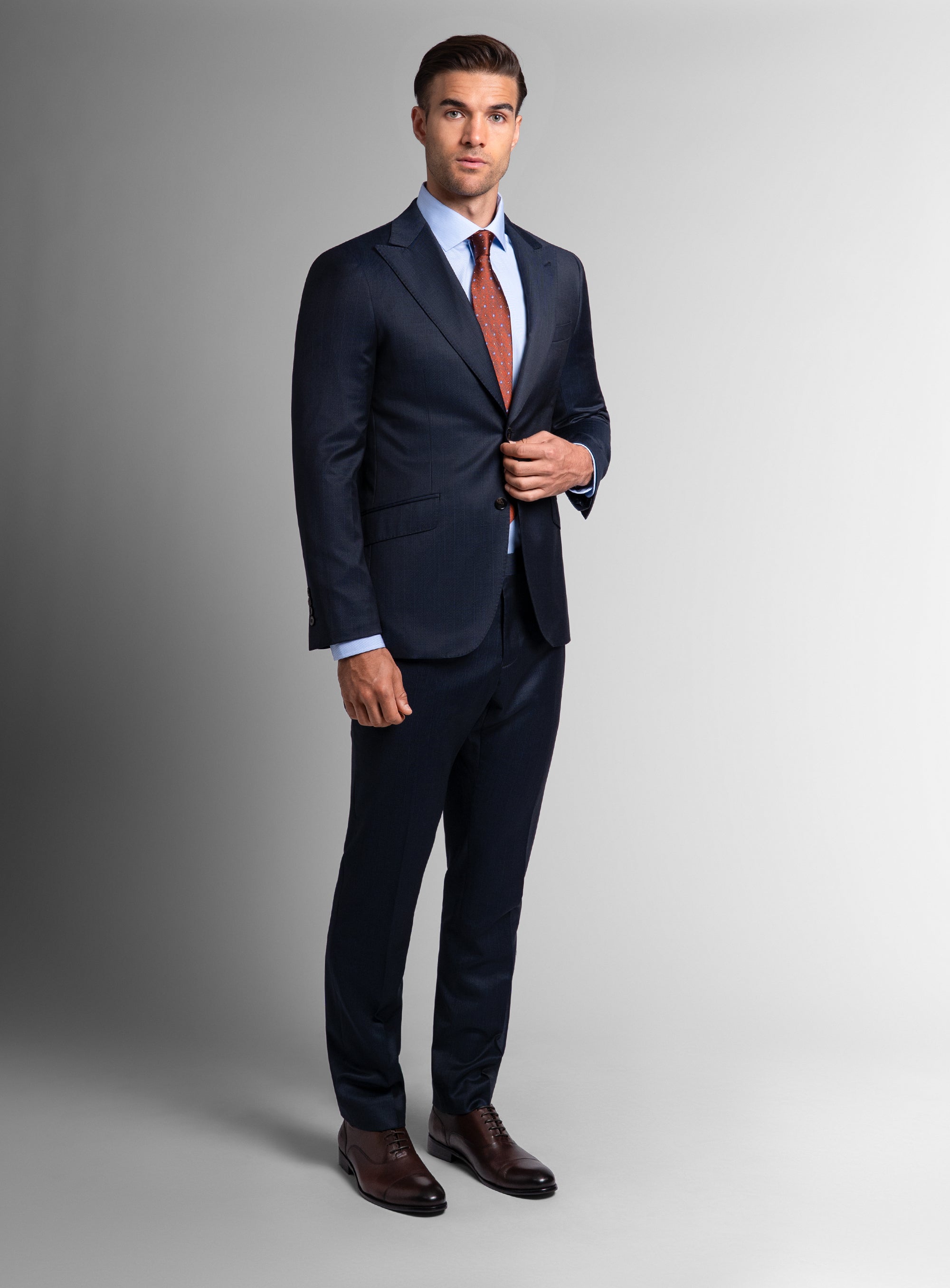 Man holding the buttons on the Laforeze Navy Pinstripe Suit