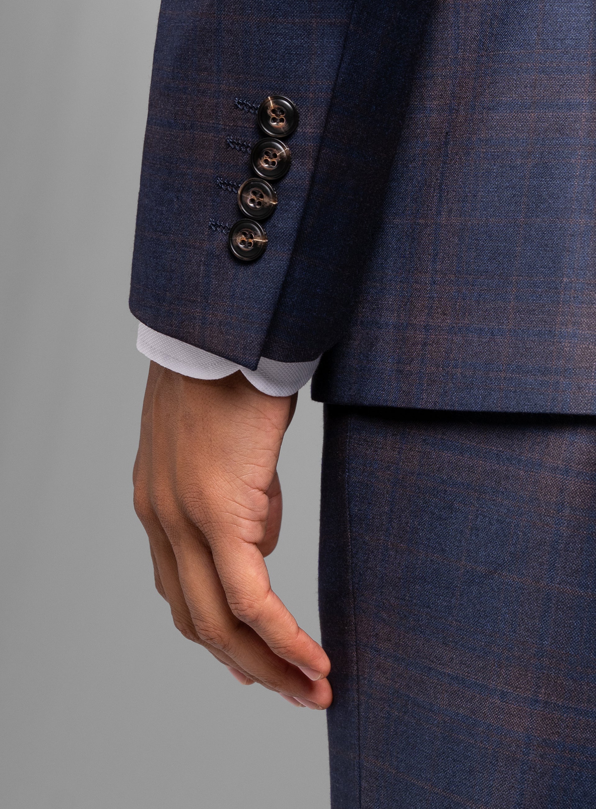 The sleeve on the Fredo Bronze Plaid Navy Suit
