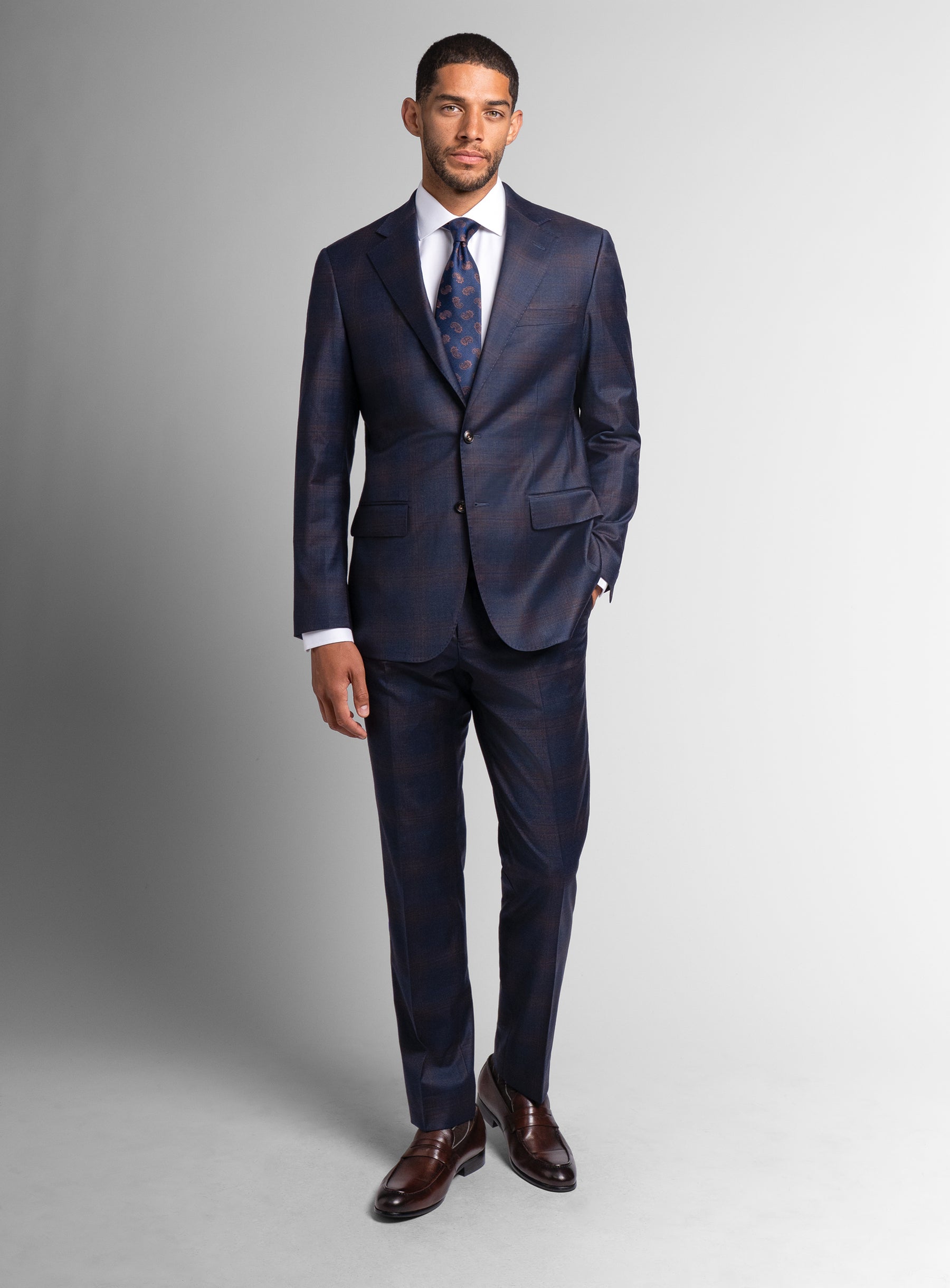 Picture of a man wearing the Fredo Bronze Plaid Navy Suit