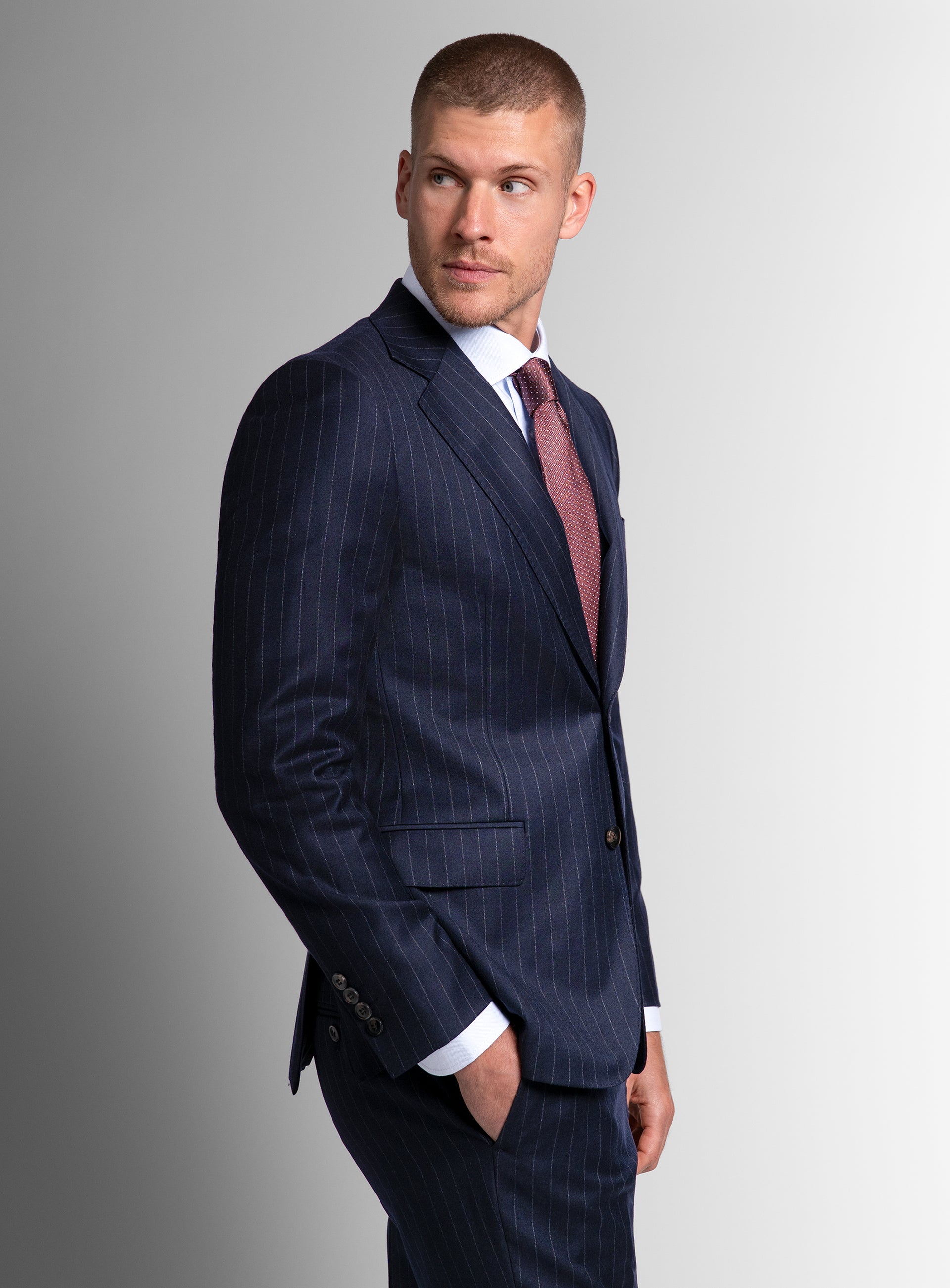Side-view of a man wearing the Ezio Navy Wide Pinstripe Suit