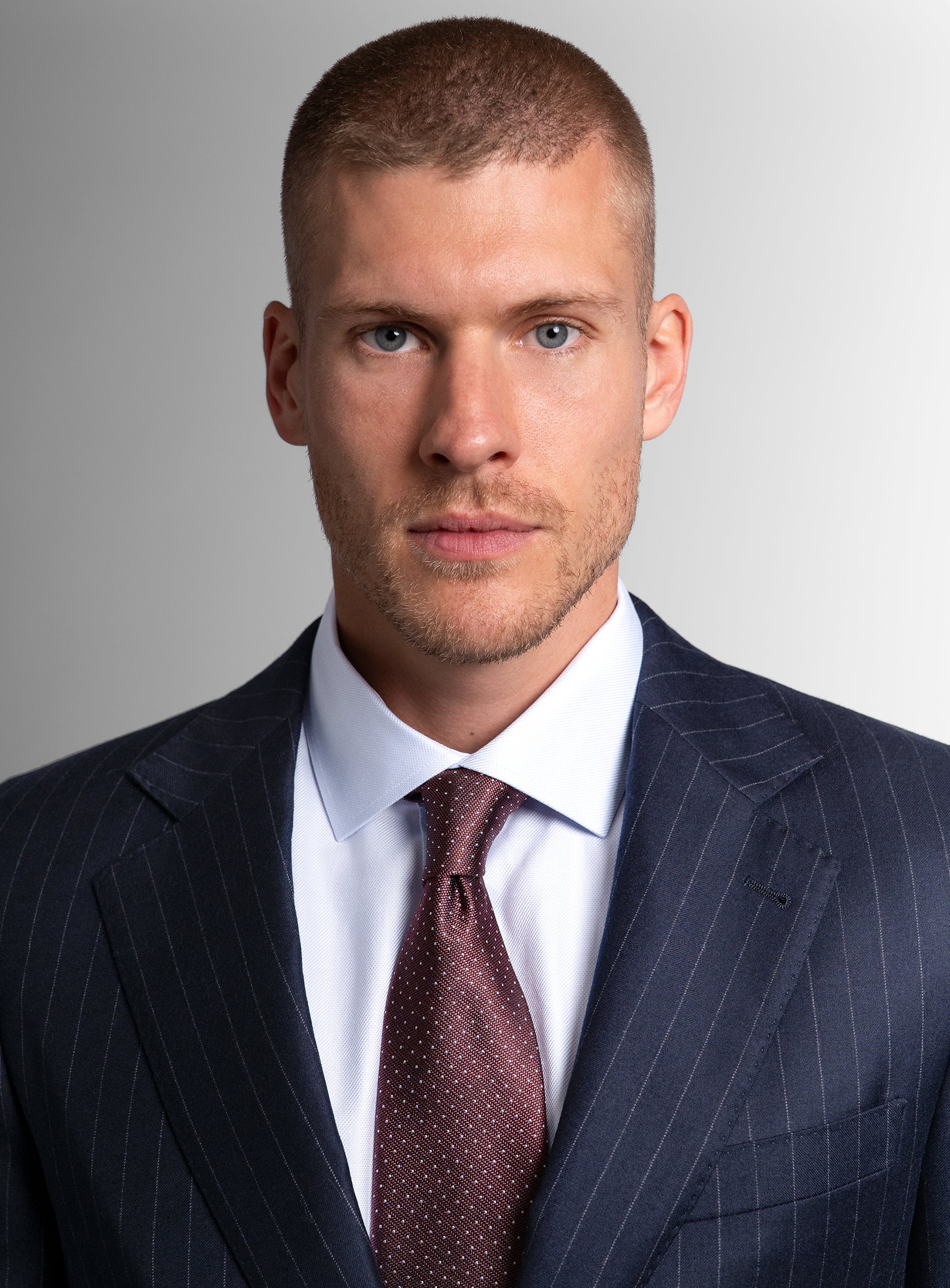 Close-up of a man wearing the Ezio Navy Wide Pinstripe Suit
