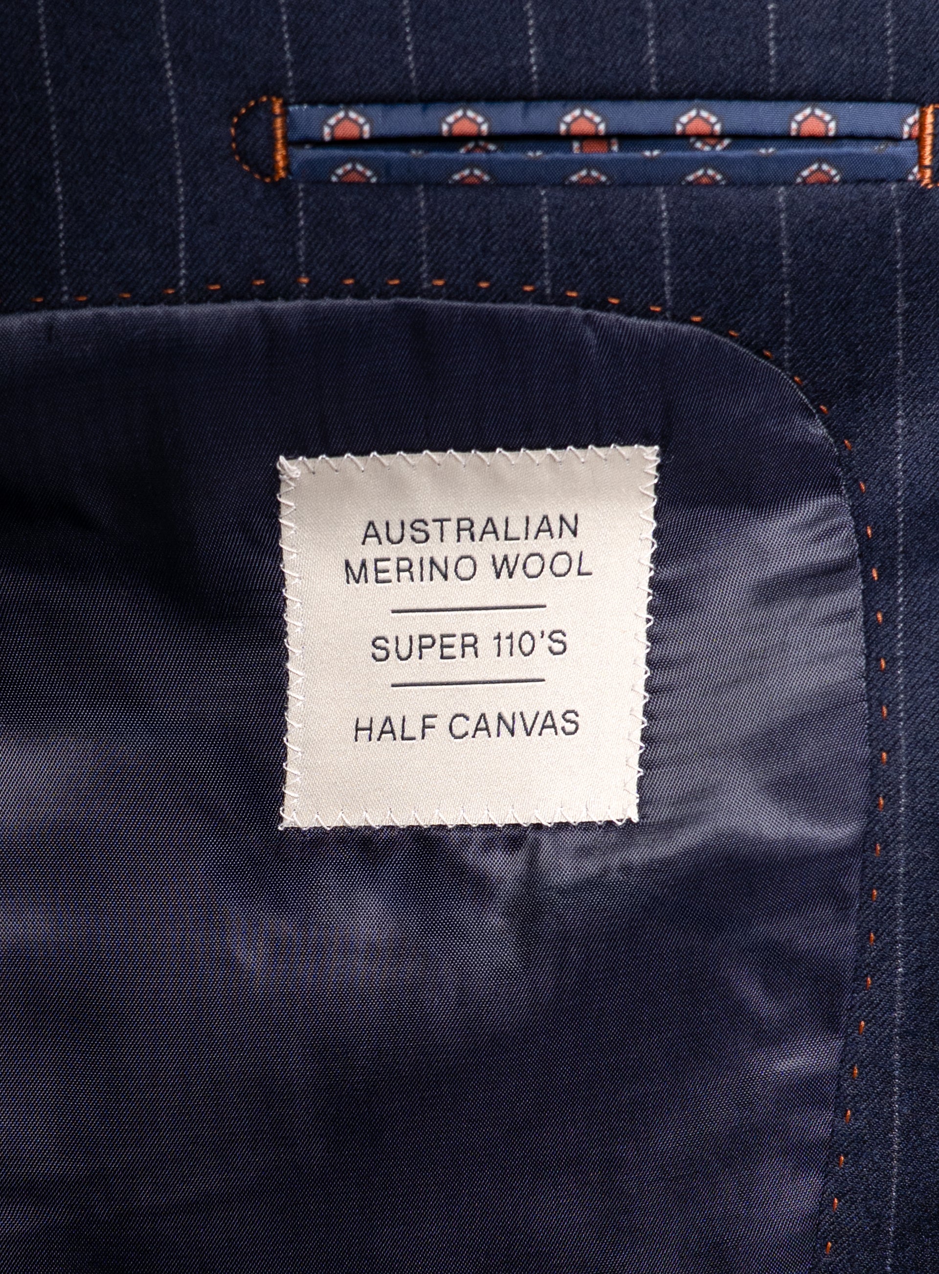 Label that says "Australian Merino Wool - Super 110s - Half Canvas" on the Ezio Navy Wide Pinstripe Suit