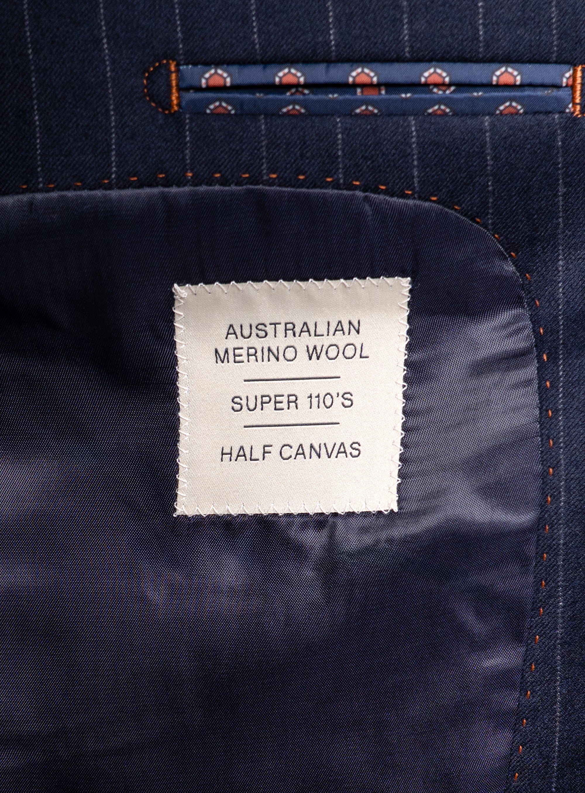 Label that says "Australian Merino Wool - Super 110s - Half Canvas" on the Ezio Navy Wide Pinstripe Suit