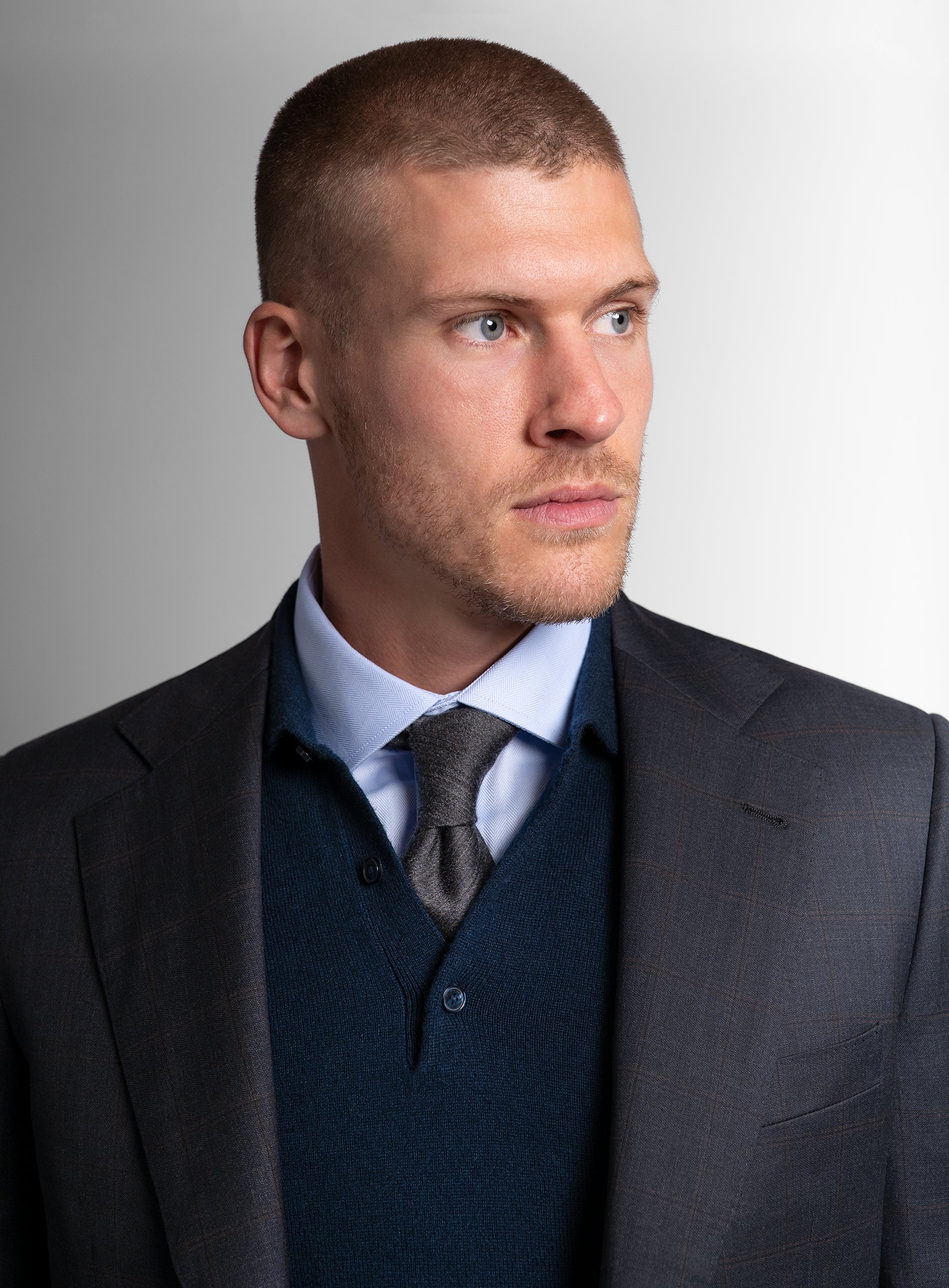Close-up of a man wearing the Volterra Navy Check Suit