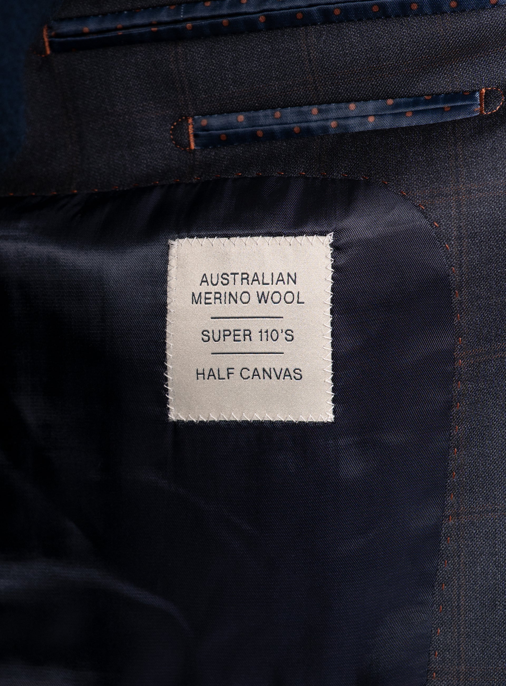 Label that says "Australian Merino Wool - Super 110's - Half Canvas" on the Volterra Navy Check Suit