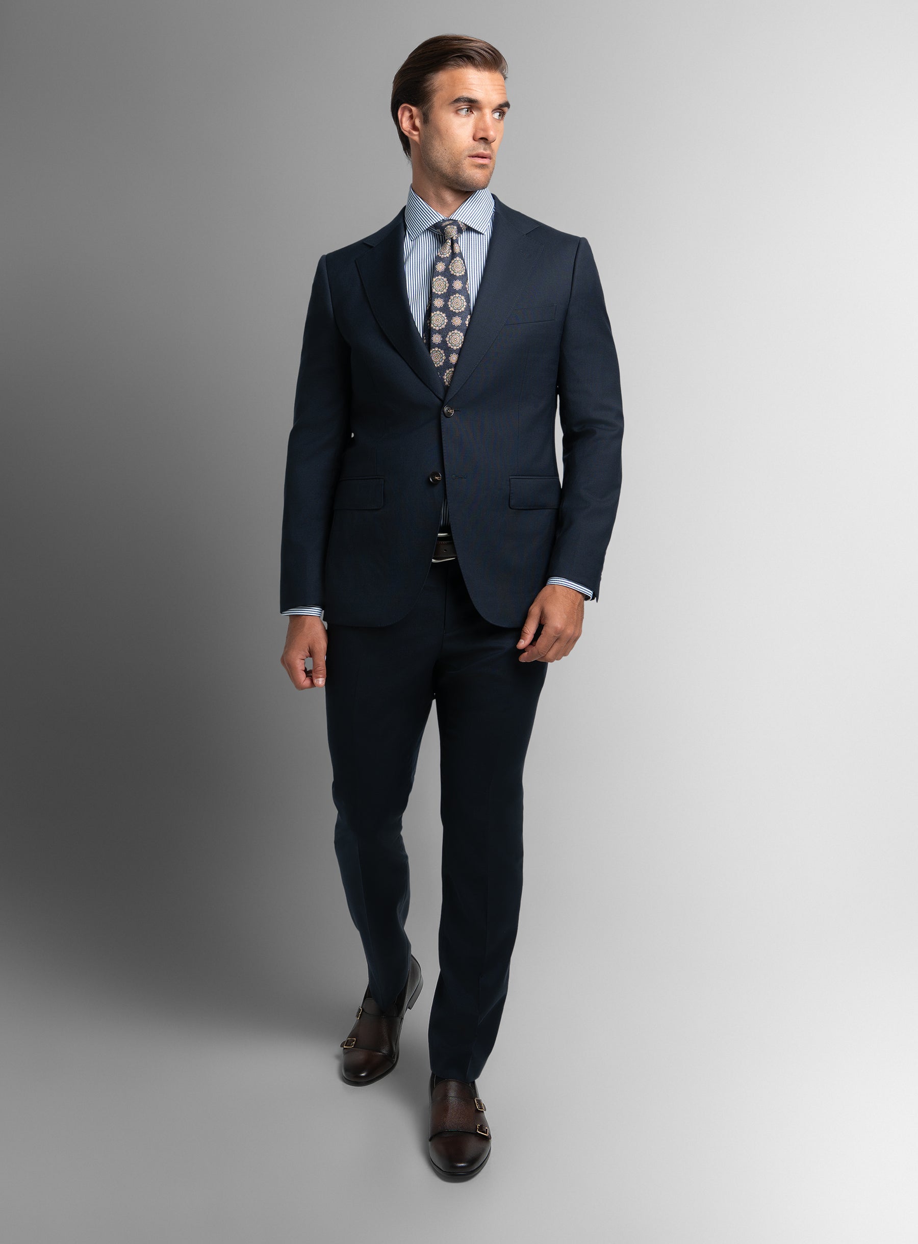 A man taking a step while wearing the Heras Basketweave Navy Suit