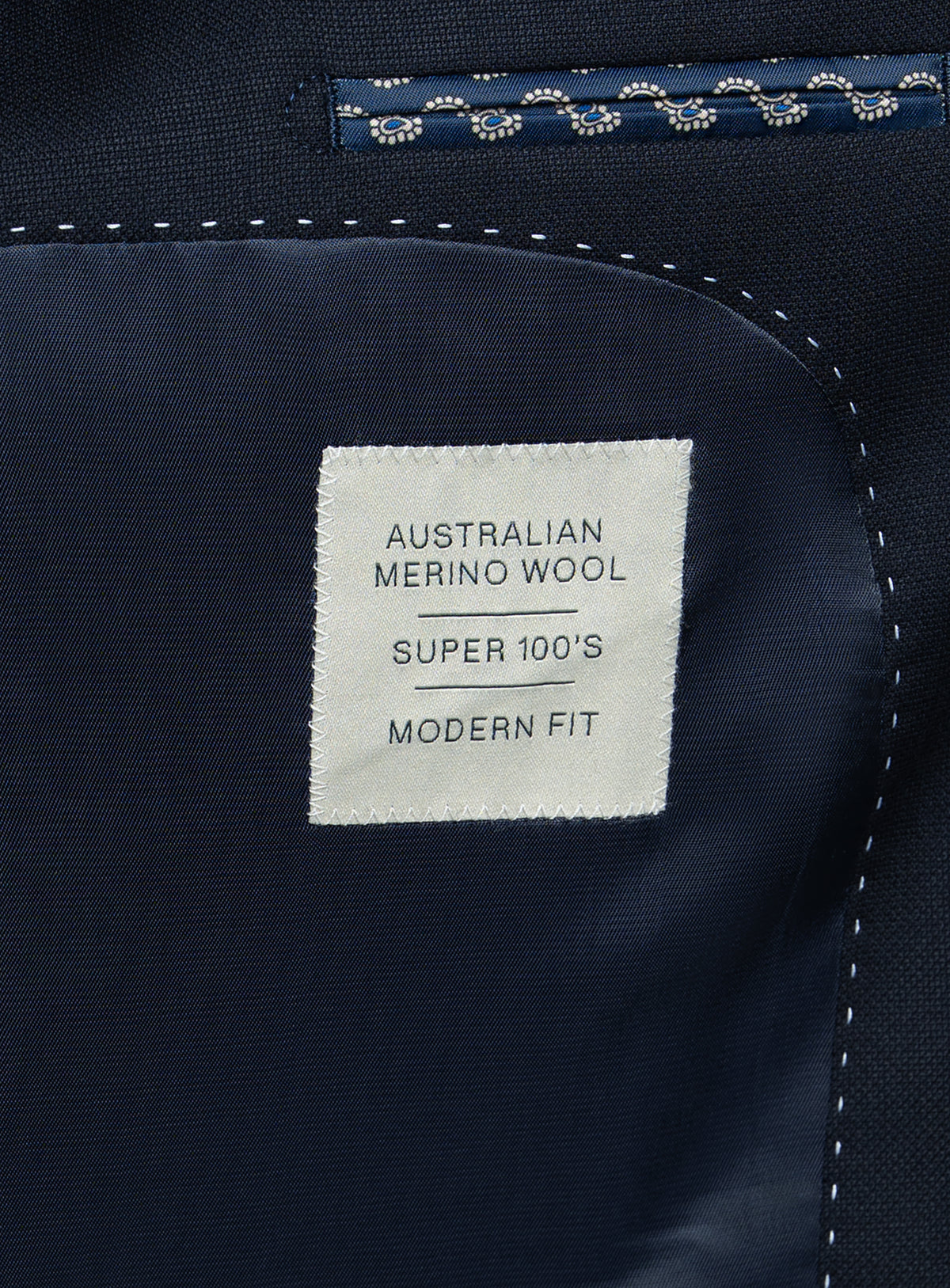 A label that says "Australian Merino Wool - Super 100's - Modern Fit" on the Heras Basketweave Navy Suit