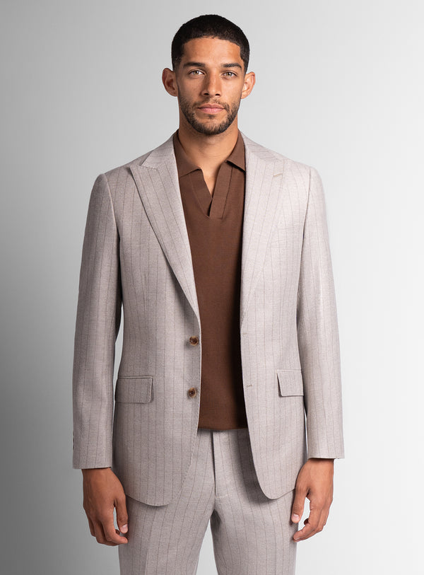 Man wearing white suit with brown shirt