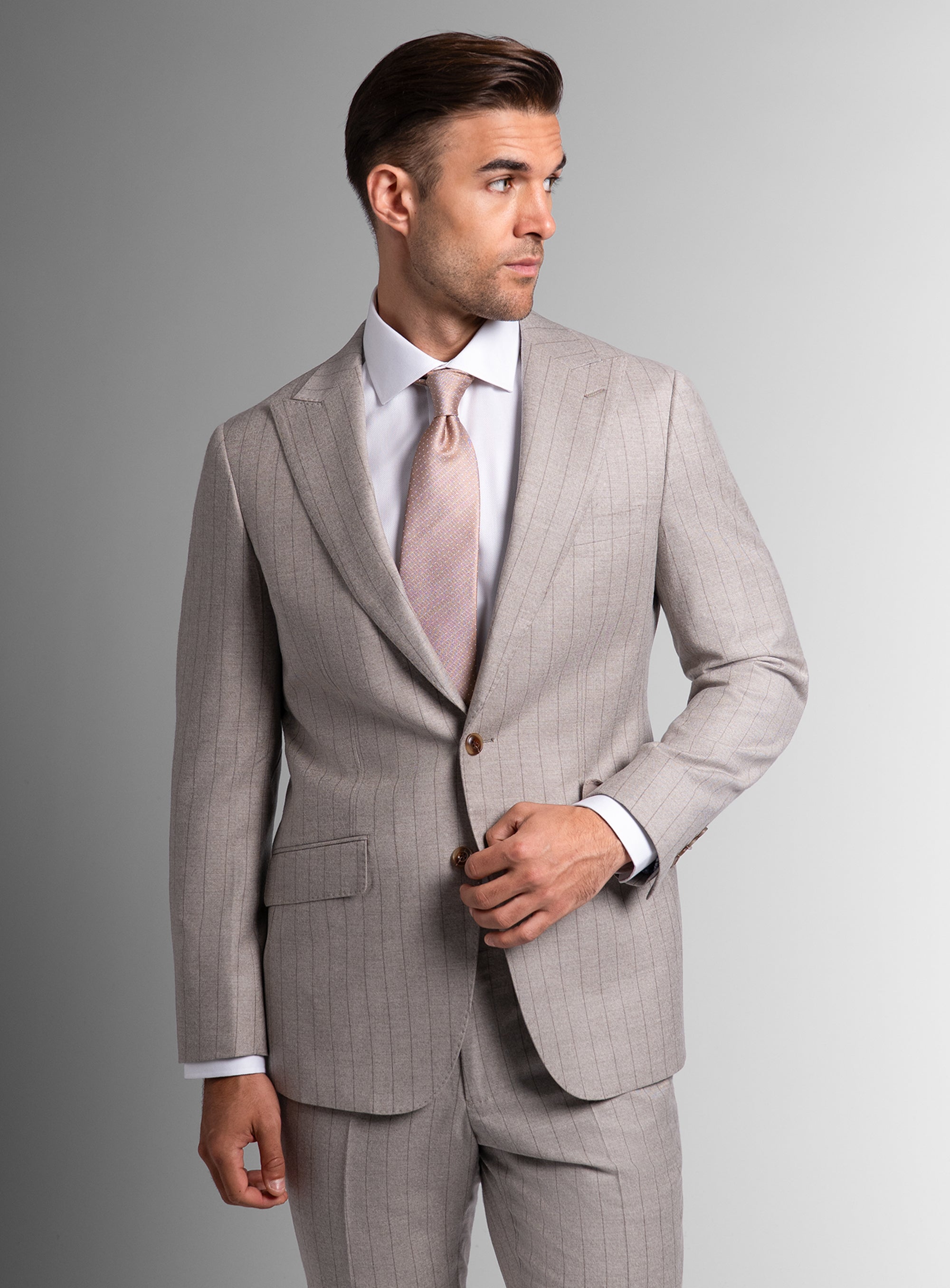 Man wearing white suit and pink tie