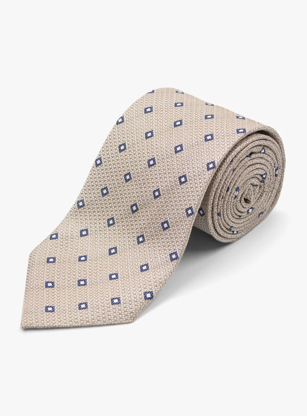 Beige tie with blue diamond pattern on a white background