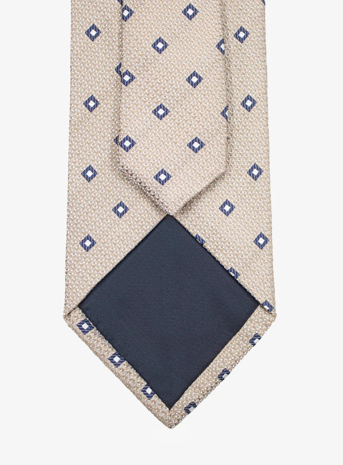 Beige tie with blue diamond pattern and matching pocket square on a white background