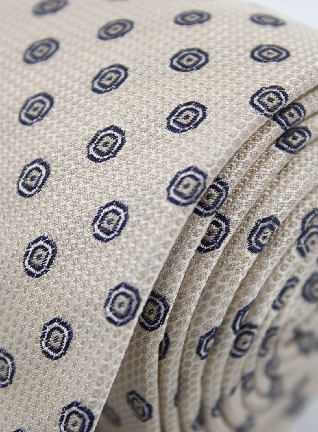 The Bottinelli Sabbia Medallion Beige Silk Tie rolled up